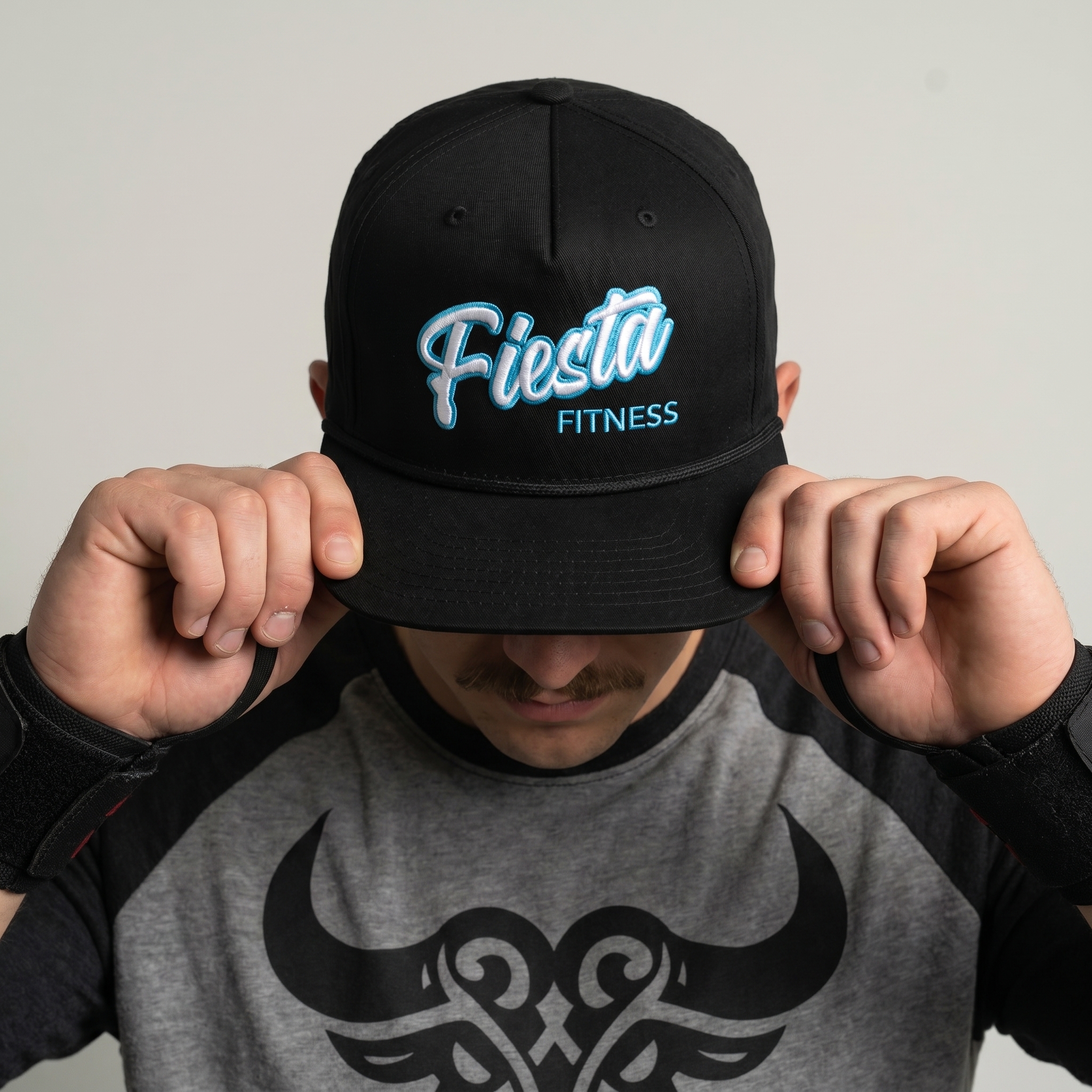 Black Fiesta Fitness rope cap with embroidered turquoise and white logo