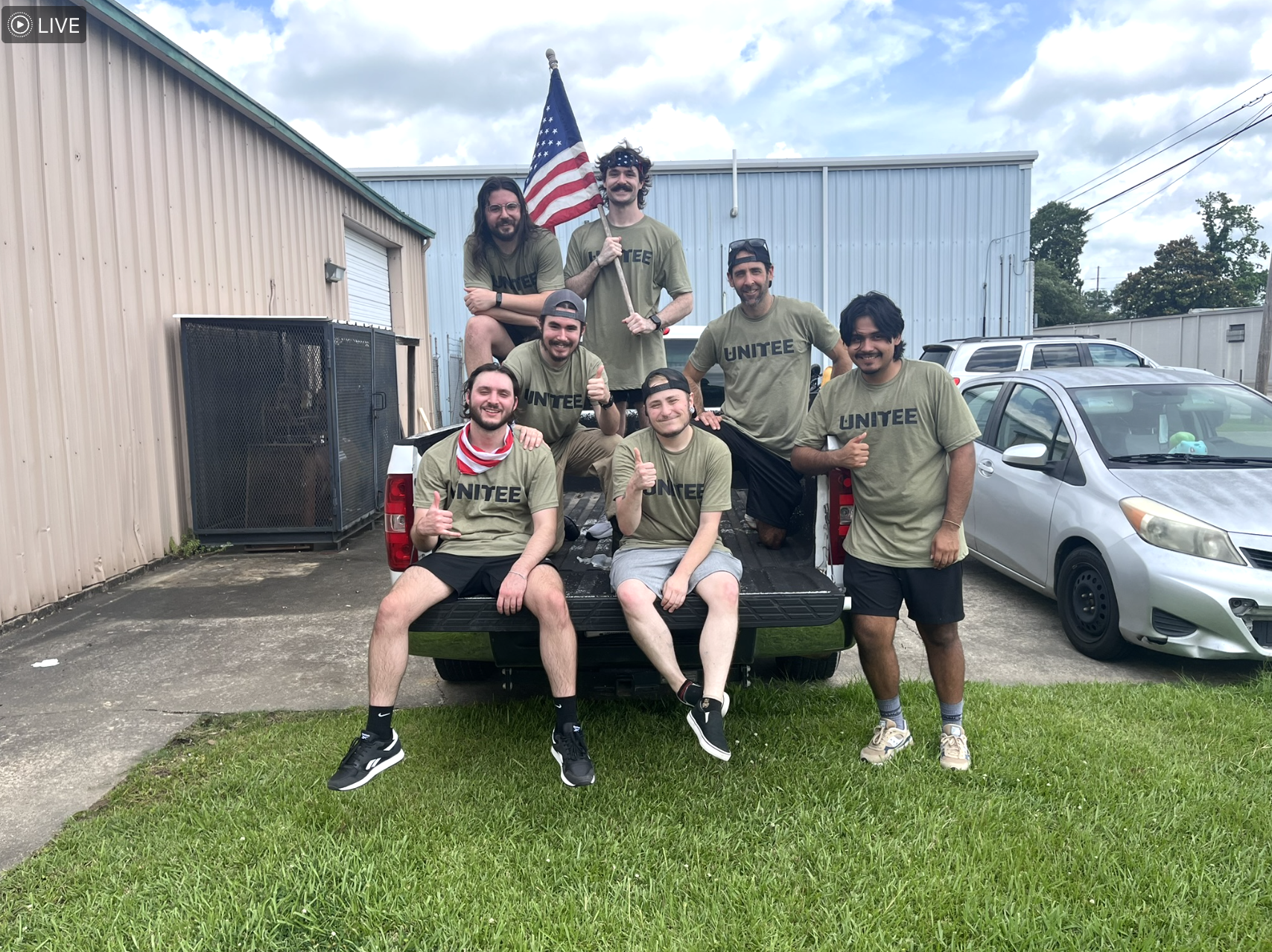 Full UNITEE team on truck with American flag