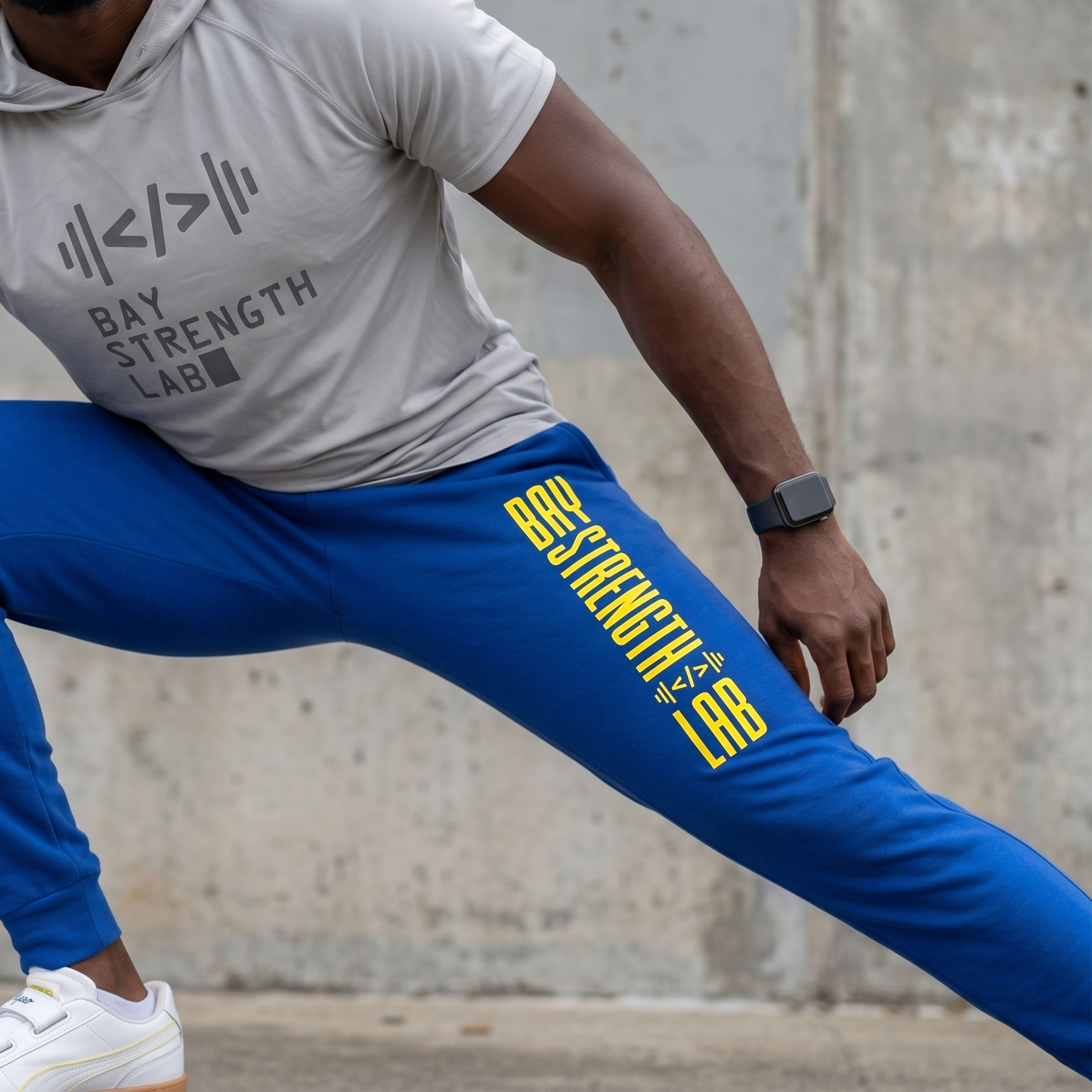 Bay Area Strength Lab gray performance hoodie with blue joggers and vertical leg print