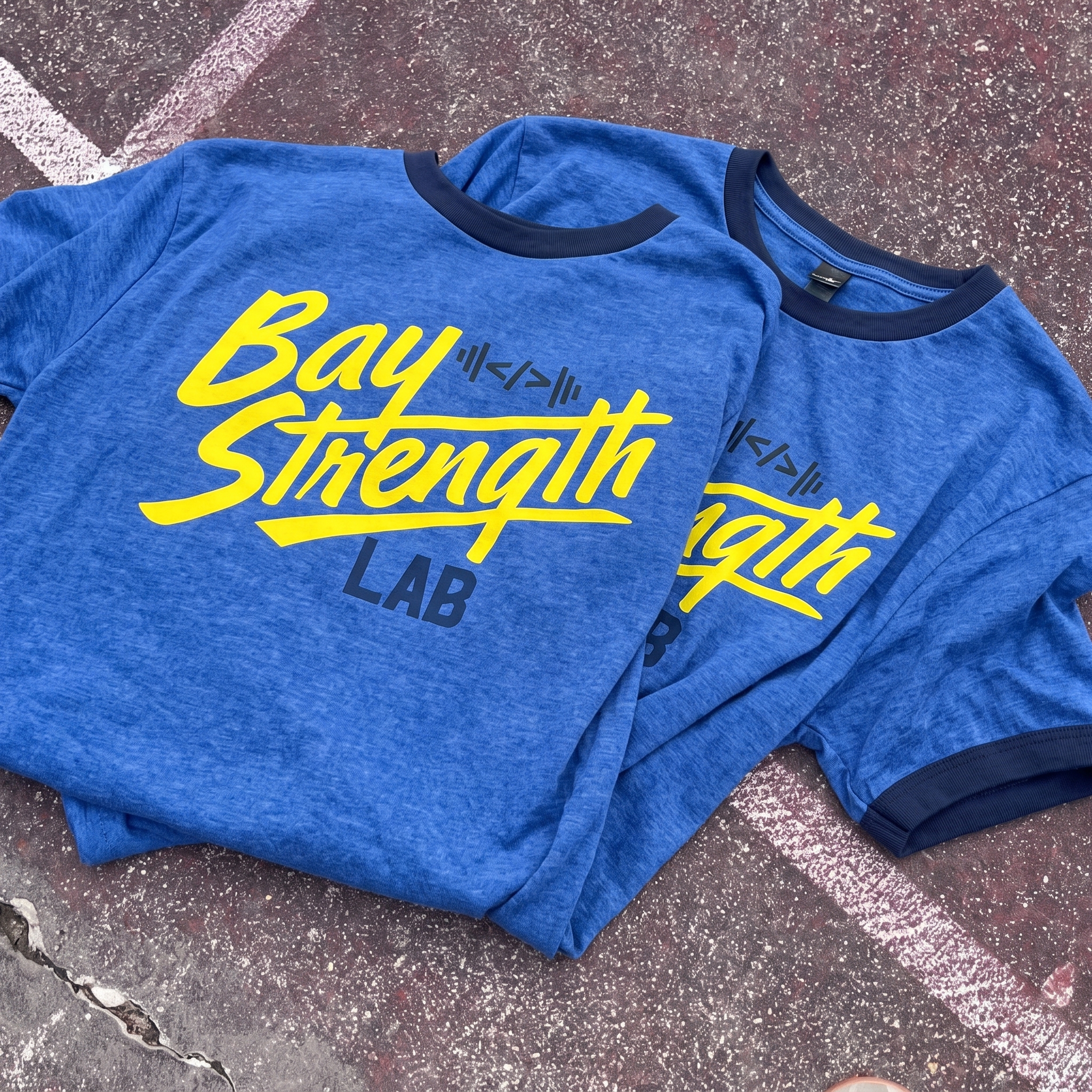 Bay Area Strength Lab blue ringer tee with yellow Bay Strength script