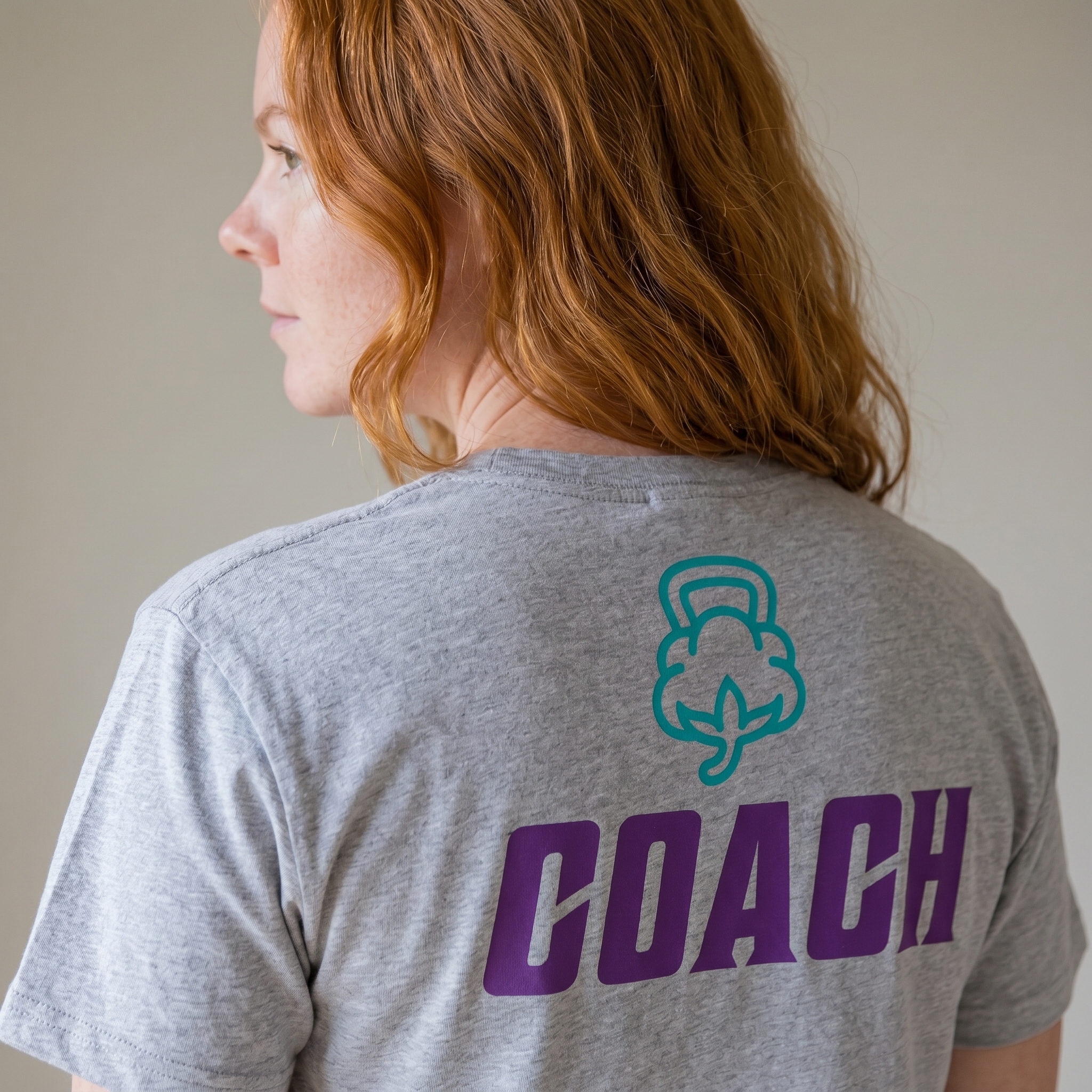 Cotton State Fitness Co. grey coach tee with purple Coach back print and teal cotton icon