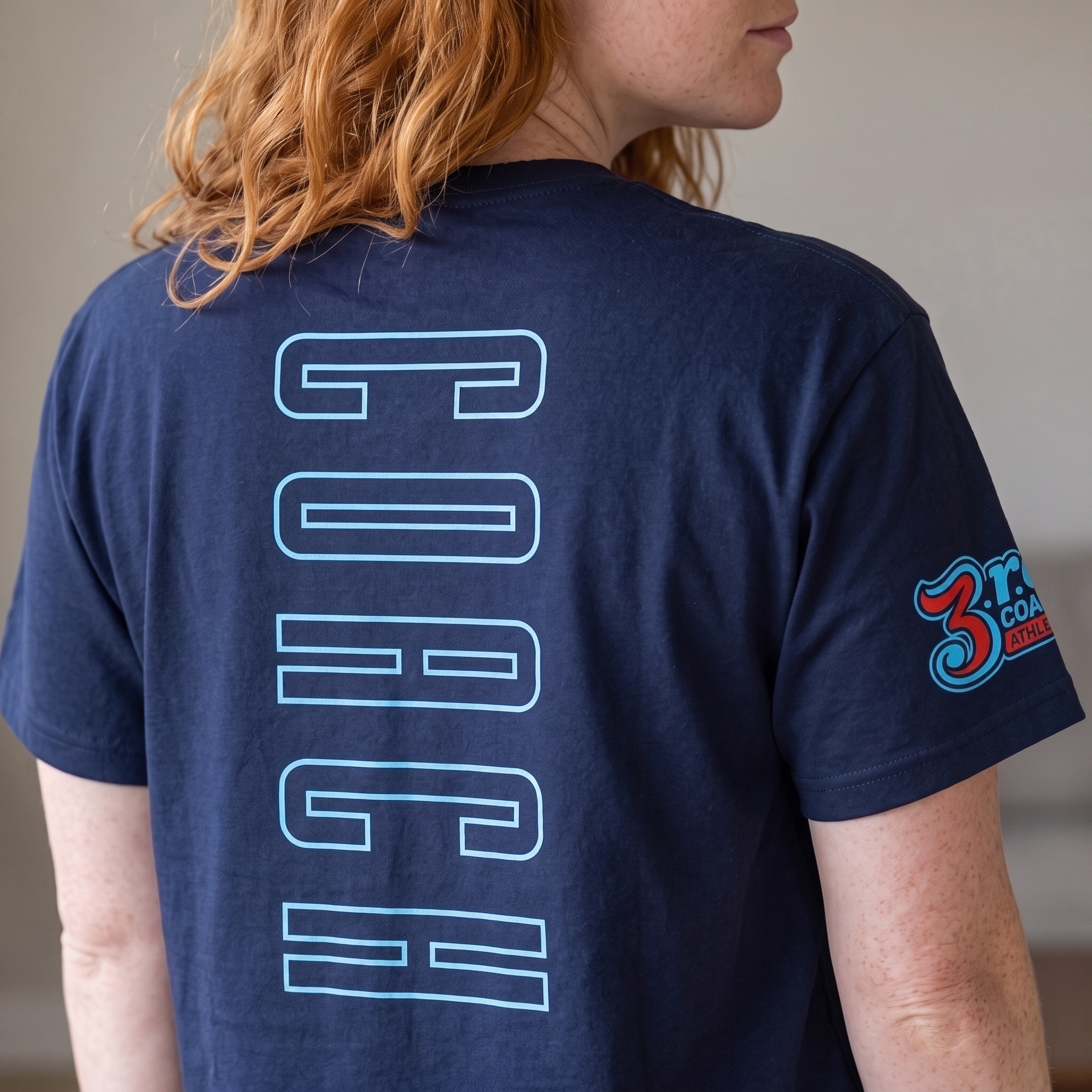 Back of navy 3rd Coast coach shirt with large outlined coach text and sleeve logo