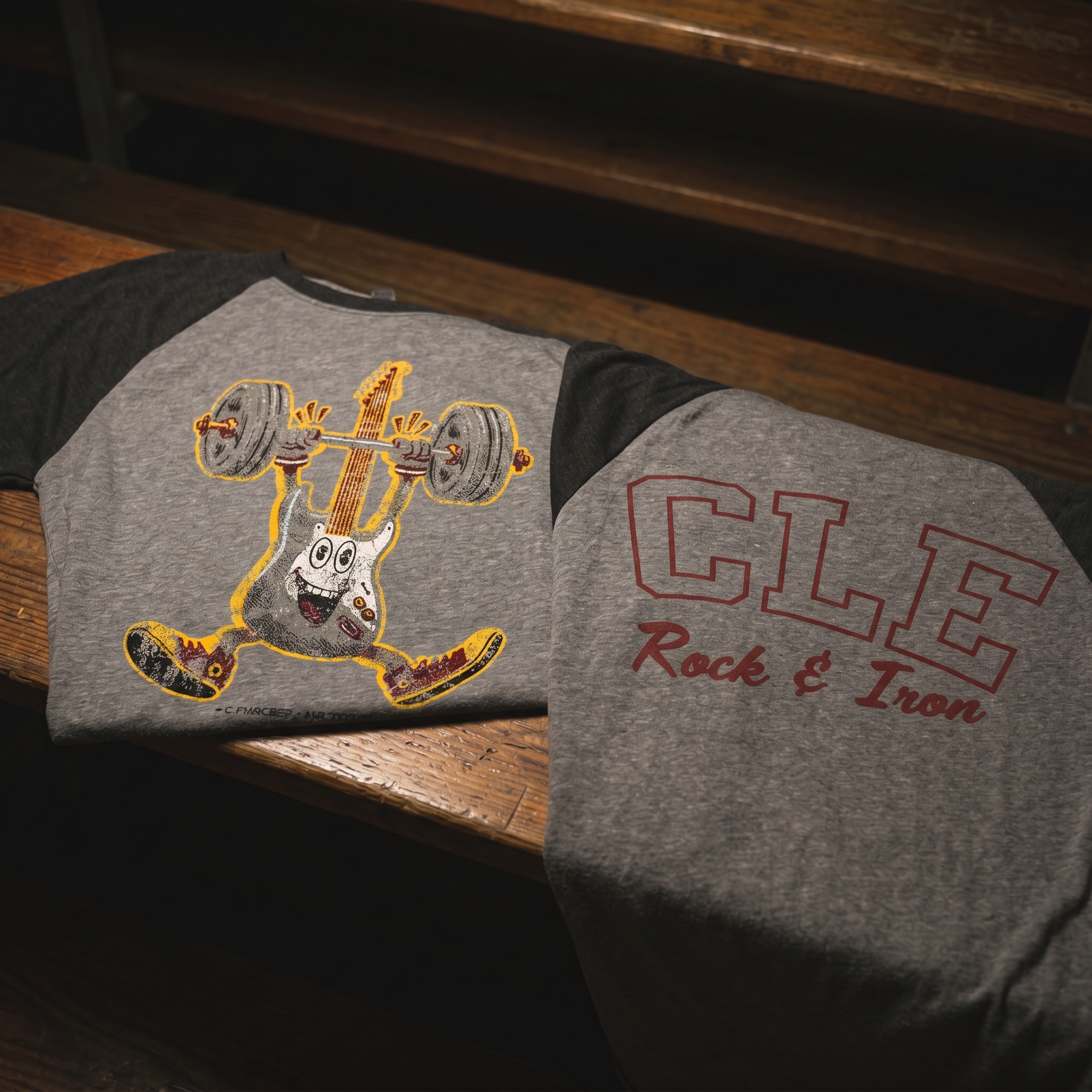 CLE Rock and Iron ringer tee with cartoon guitar lifting a barbell