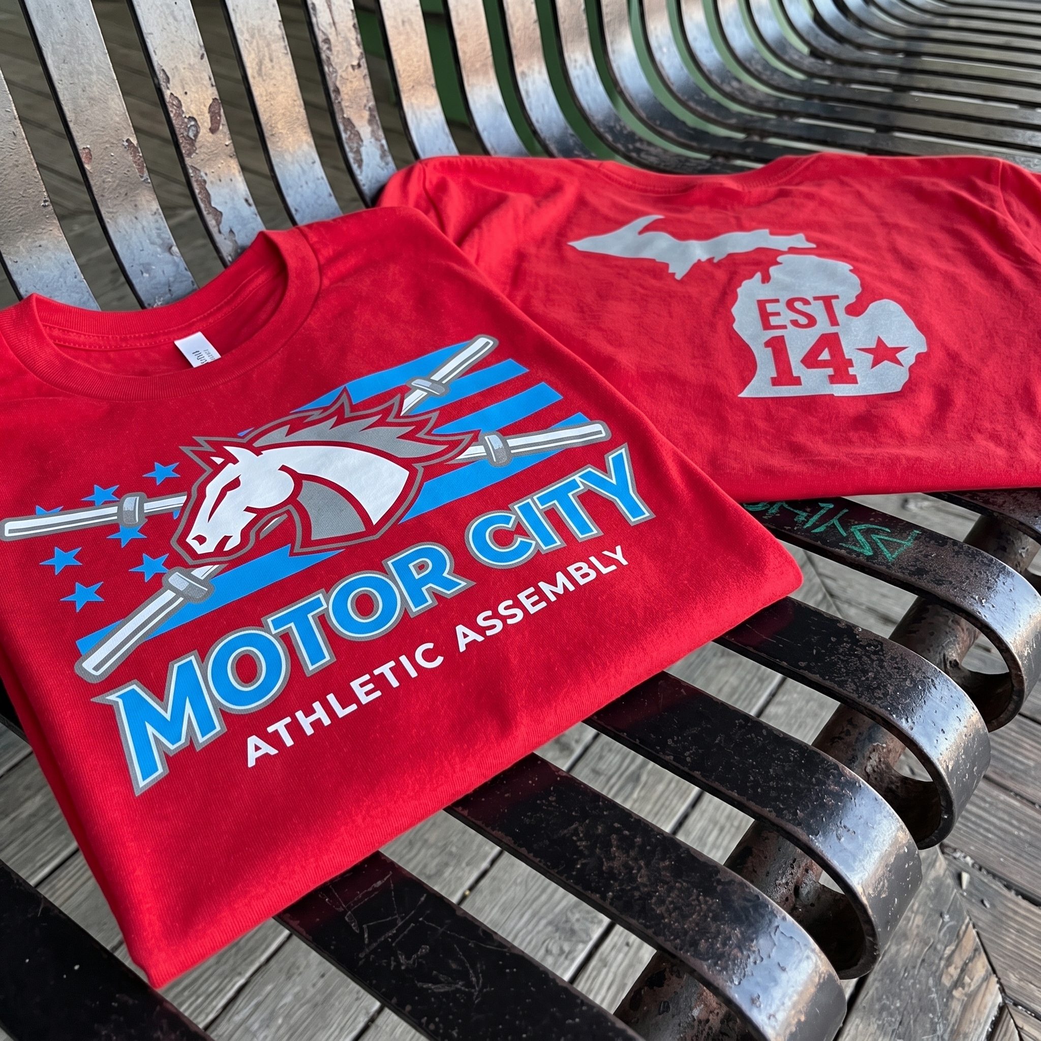 Motor City Athletic Assembly red tee with Michigan state back mark