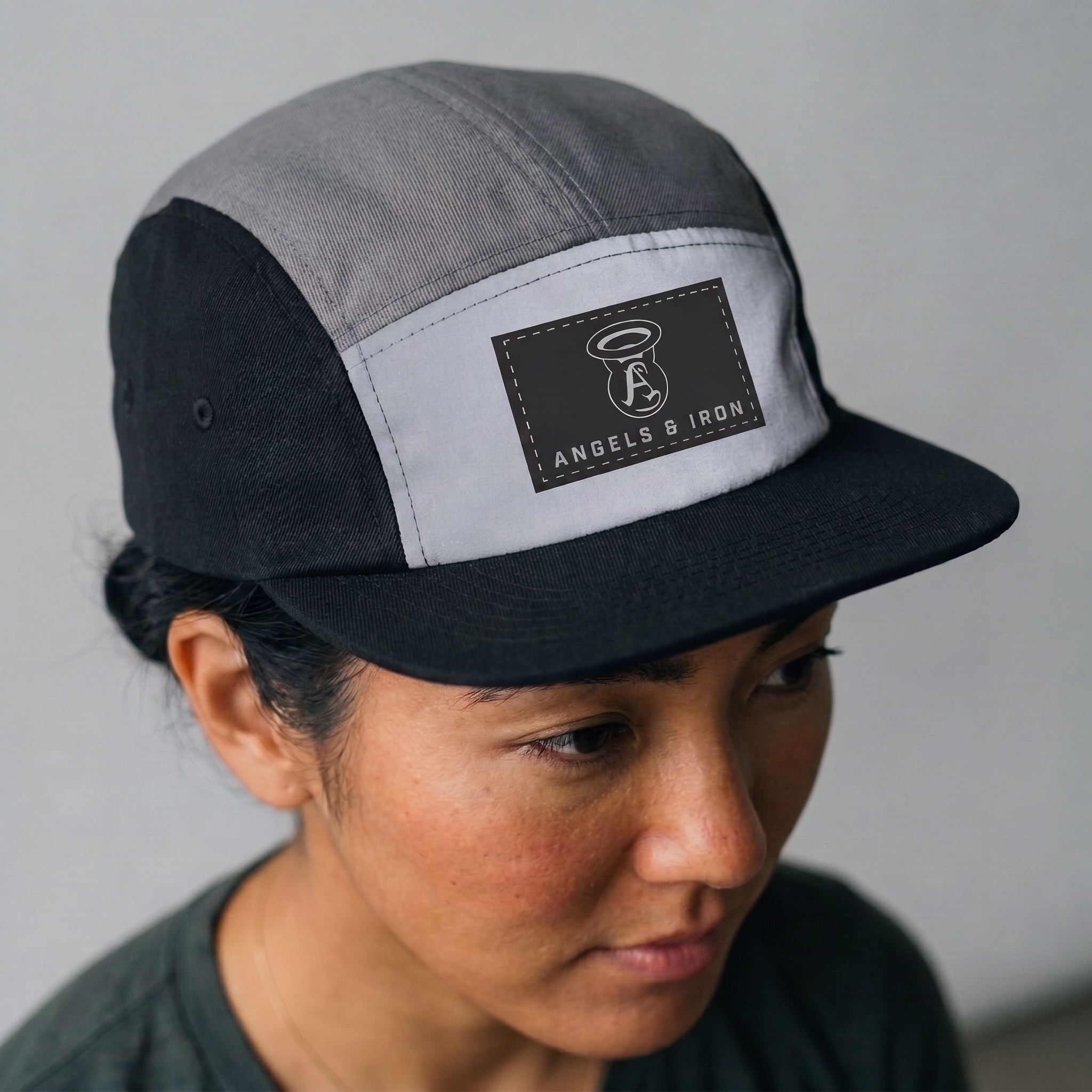 Black and grey Angels and Iron five-panel hat with rectangular patch logo