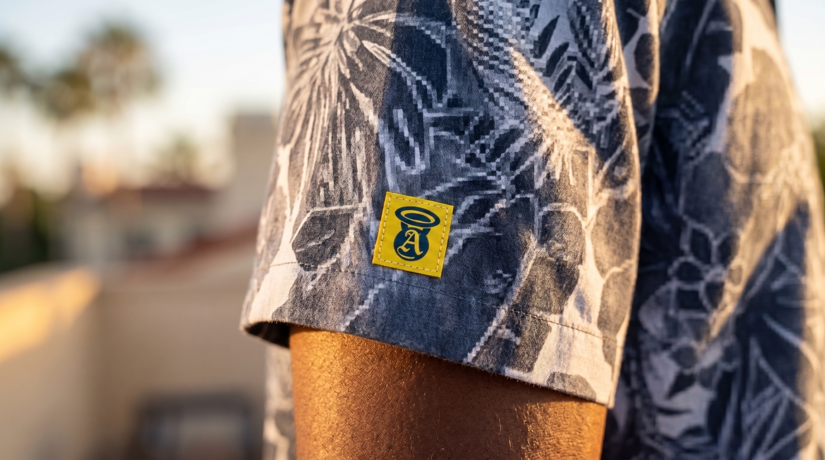 Close-up of Angels and Iron yellow sleeve patch on blue floral camp shirt