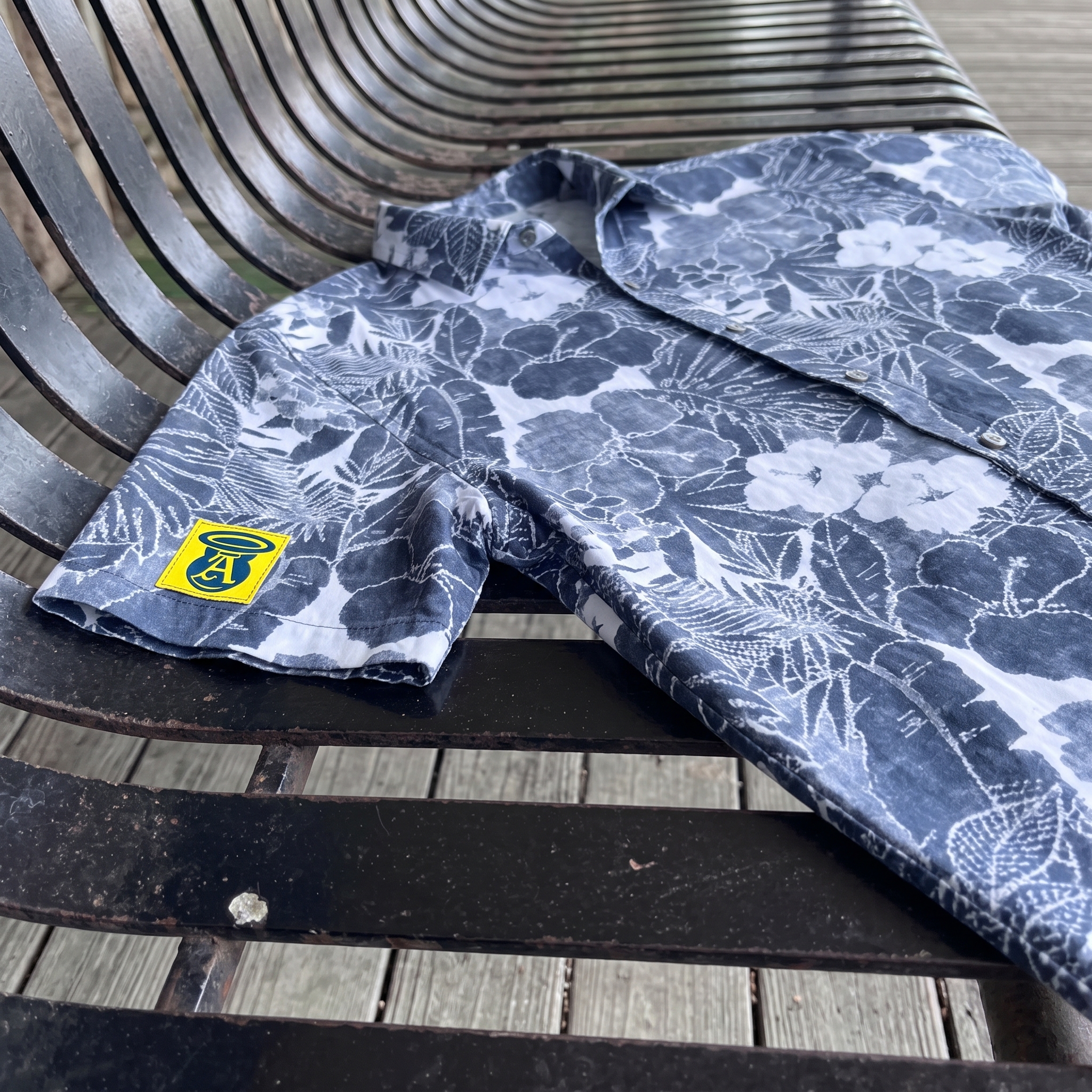 Blue and white floral Angels and Iron camp shirt with small yellow sleeve patch