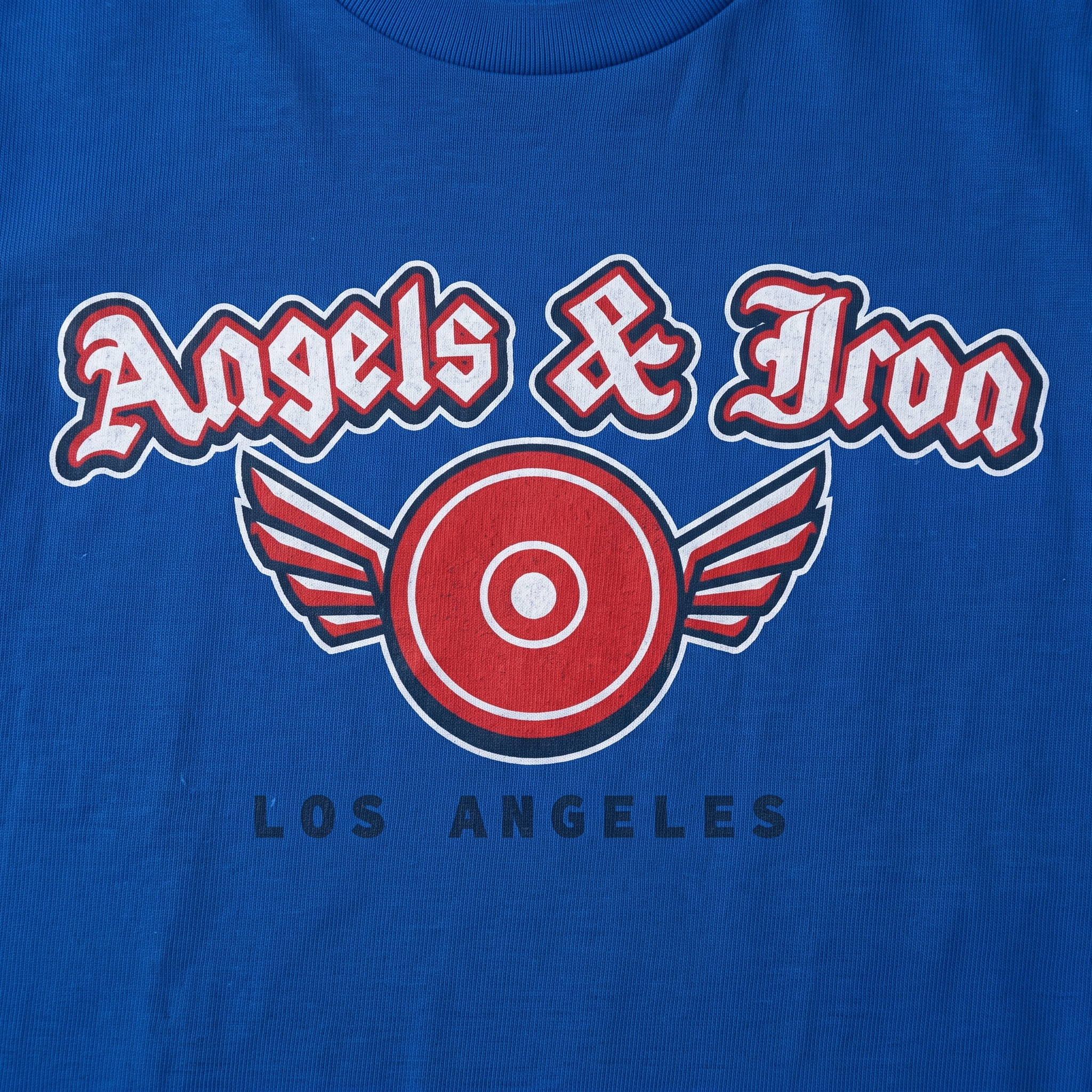 Close-up of Angels and Iron screen printed graphic on blue garment