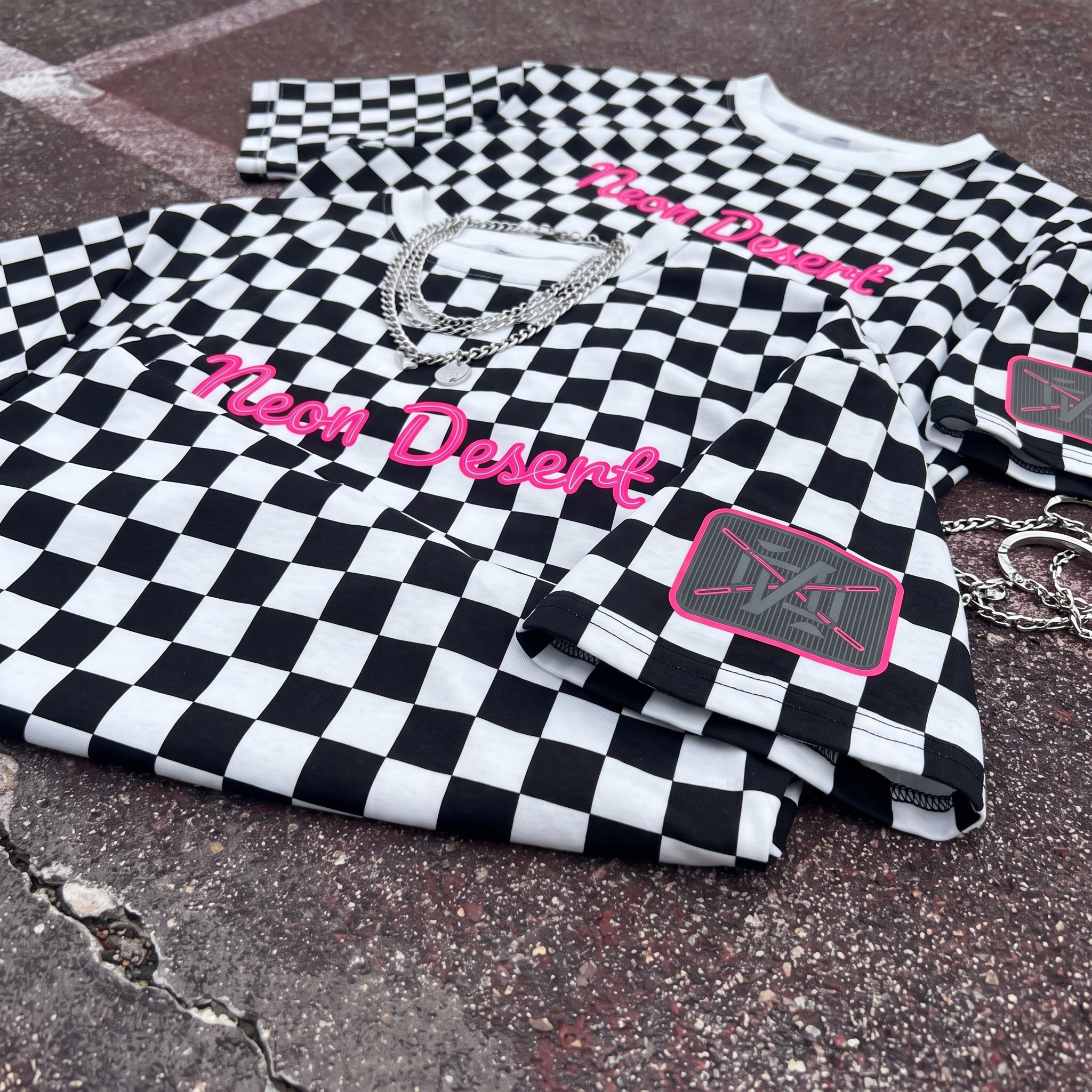 Neon Desert checkerboard tee with pink logo and sleeve patch