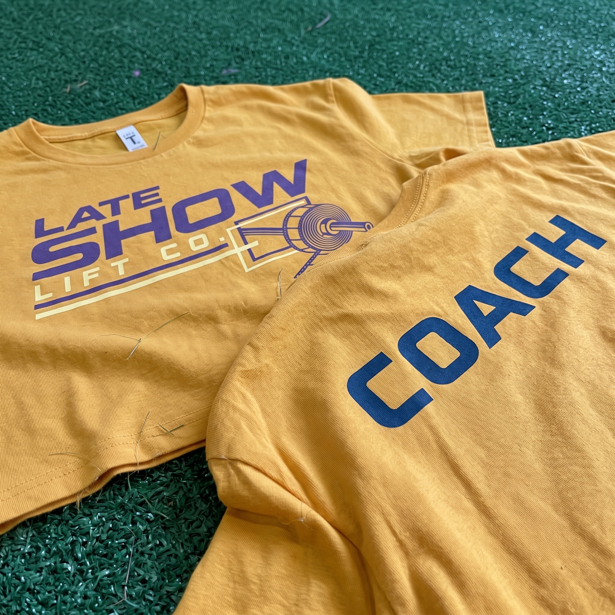 Late Show Lift Co black tank and orange tee with rocket and Lift Off graphics