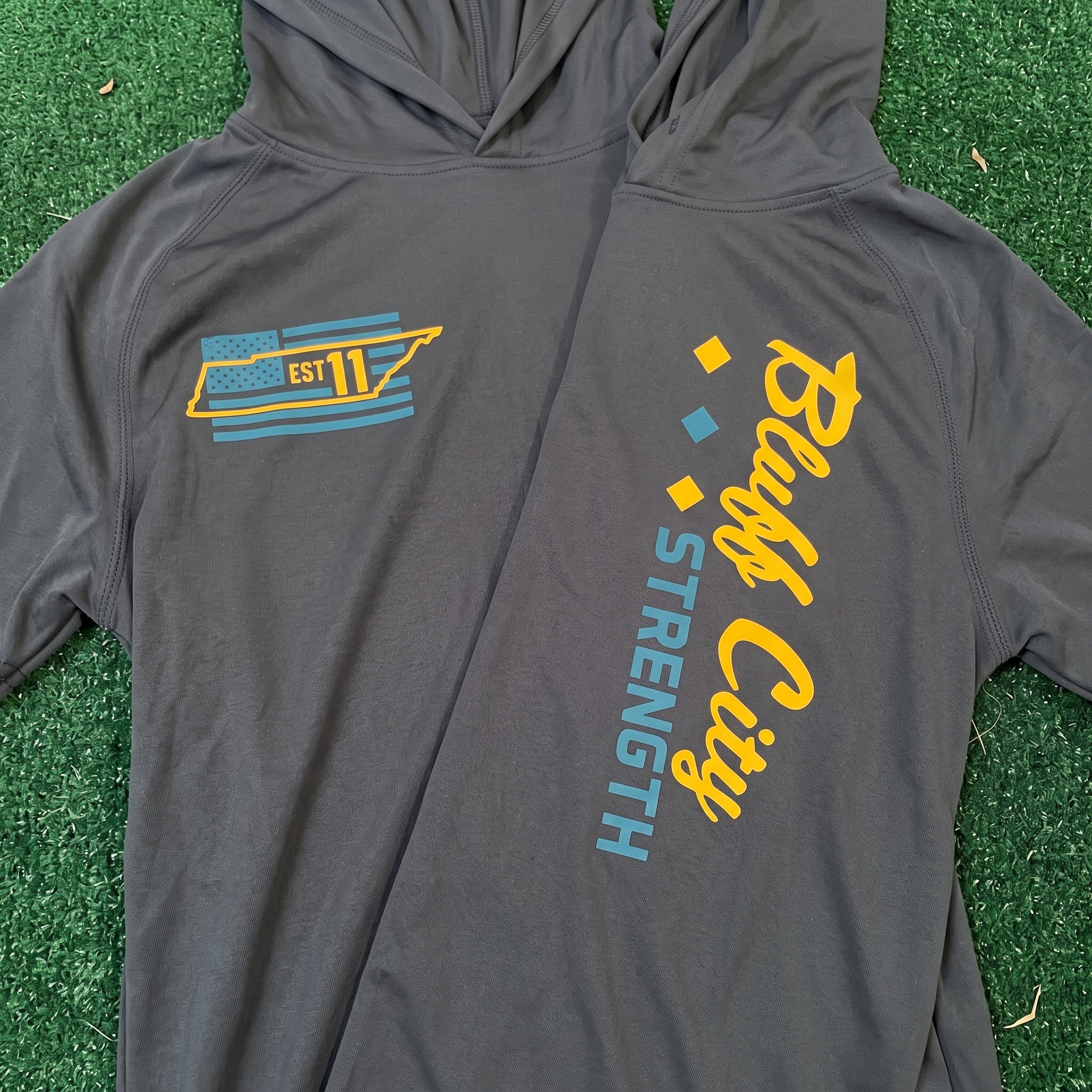 Bluff City Strength Co training set with hoodie, tees, beanie, joggers, and raglan