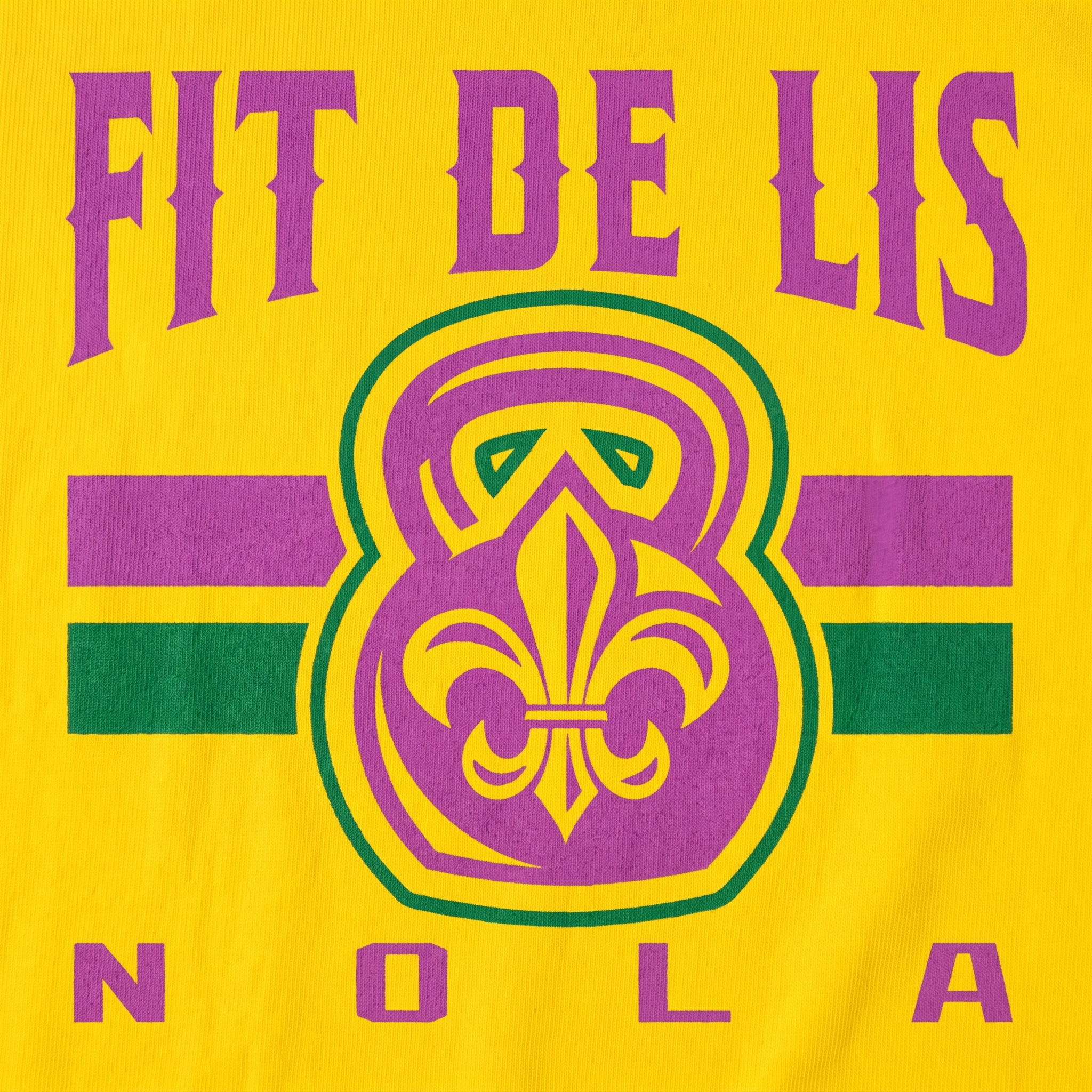 Close-up of Fit De Lis screen printed logo on yellow fabric with purple, green, and gold fleur-de-lis kettlebell mark
