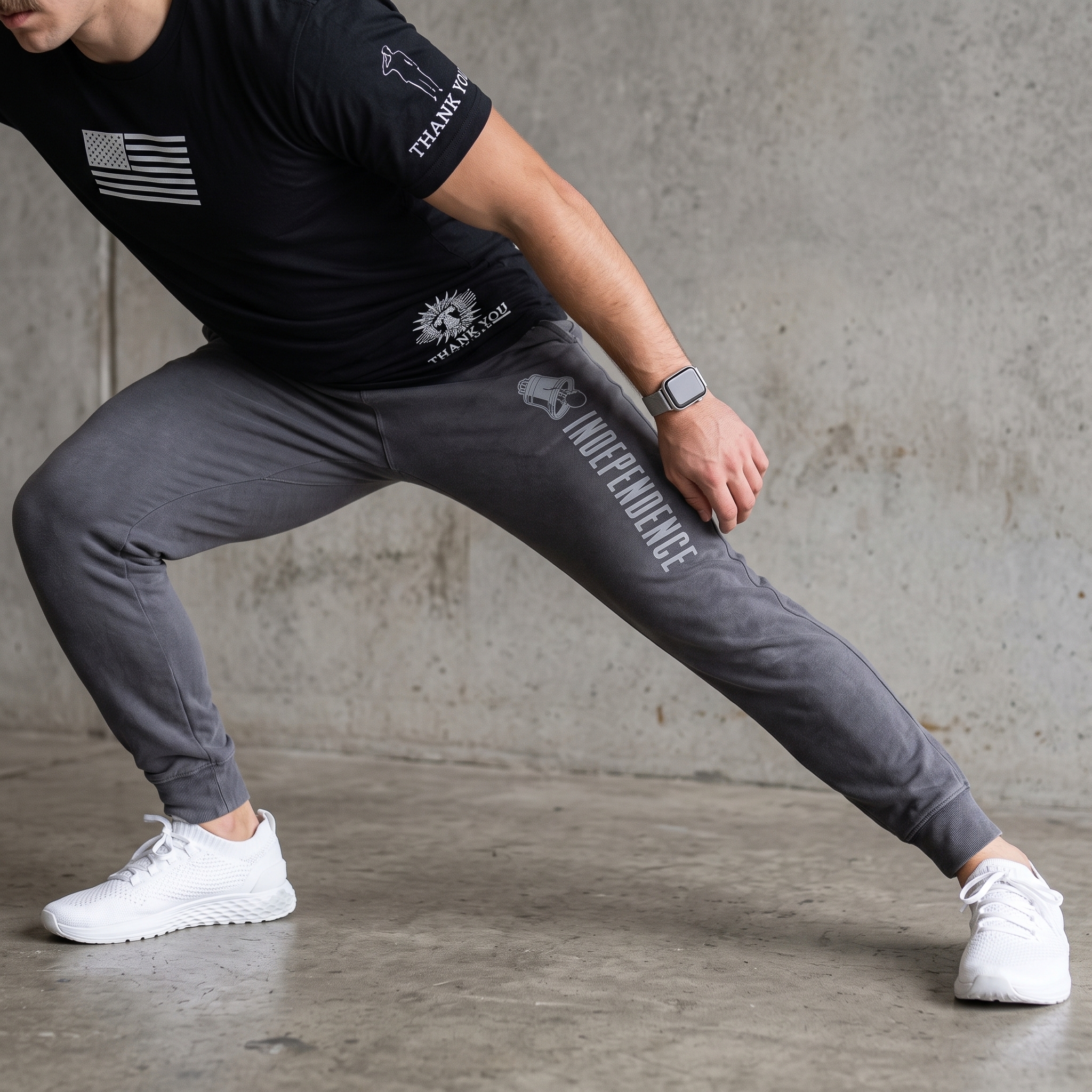 Athlete wearing grey Independence Barbell training bottoms with vertical Independence lettering and Liberty Bell icon