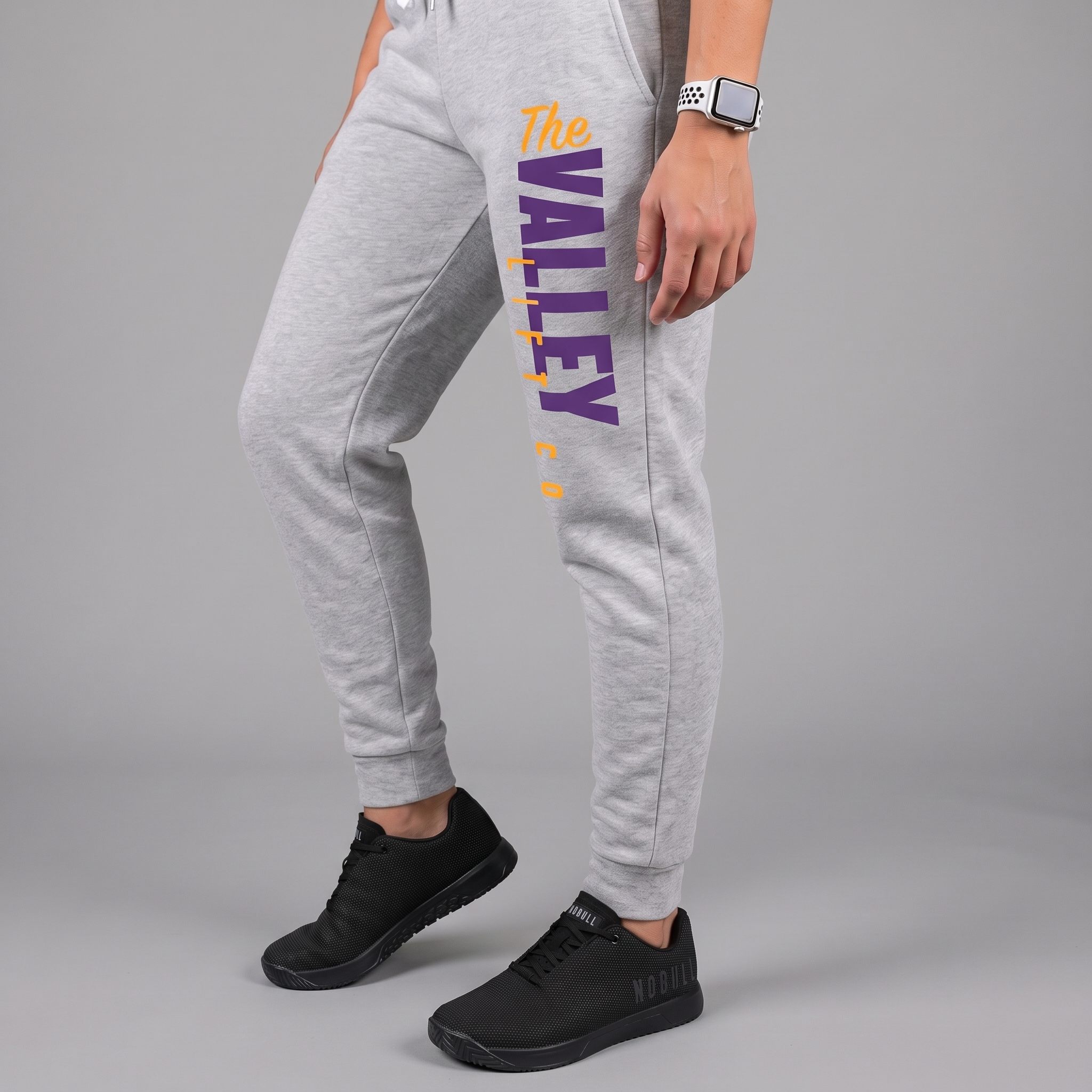 Grey The Valley Lift Co joggers with vertical purple and yellow logo placement