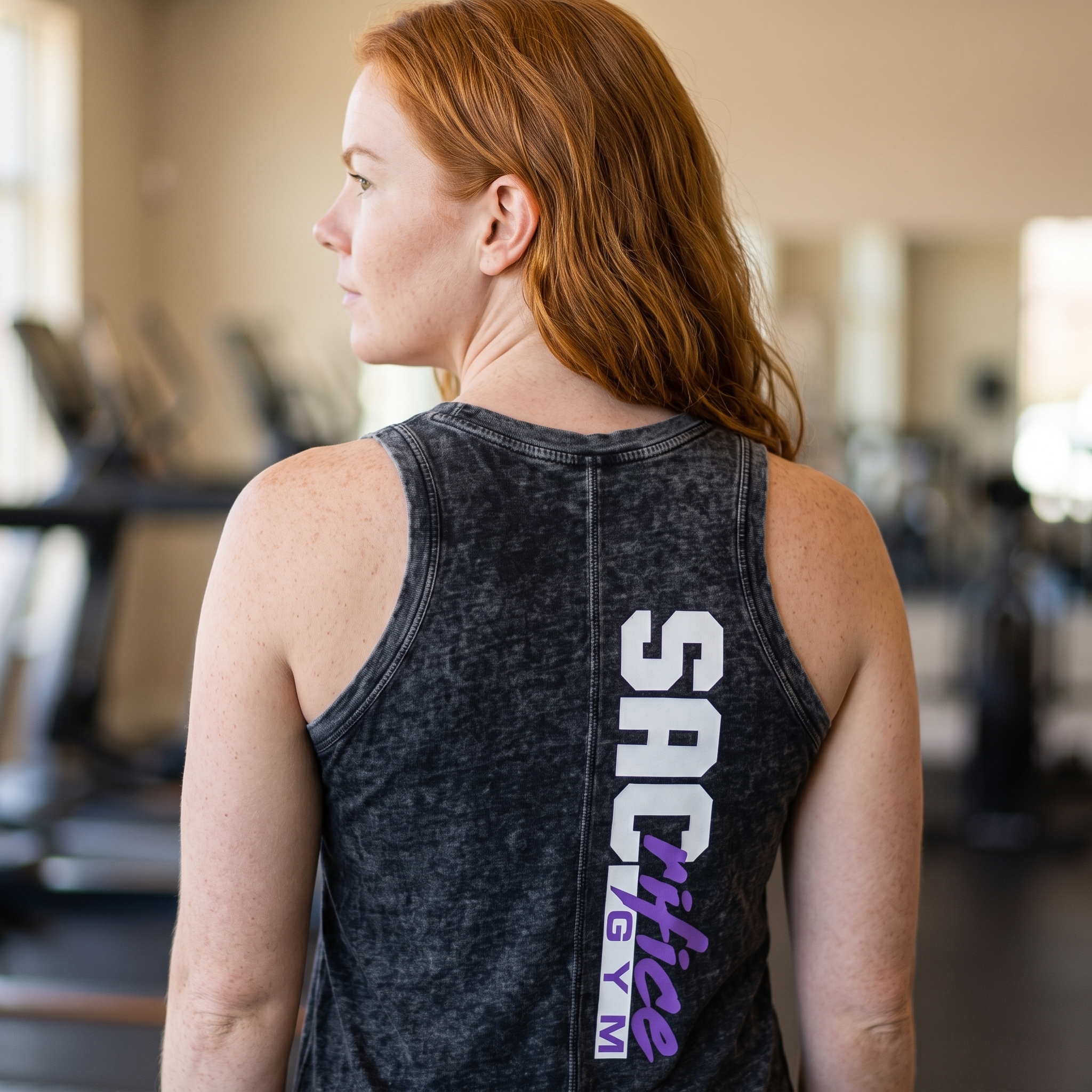 Back view of black washed tank with vertical SACrifice Gym logo