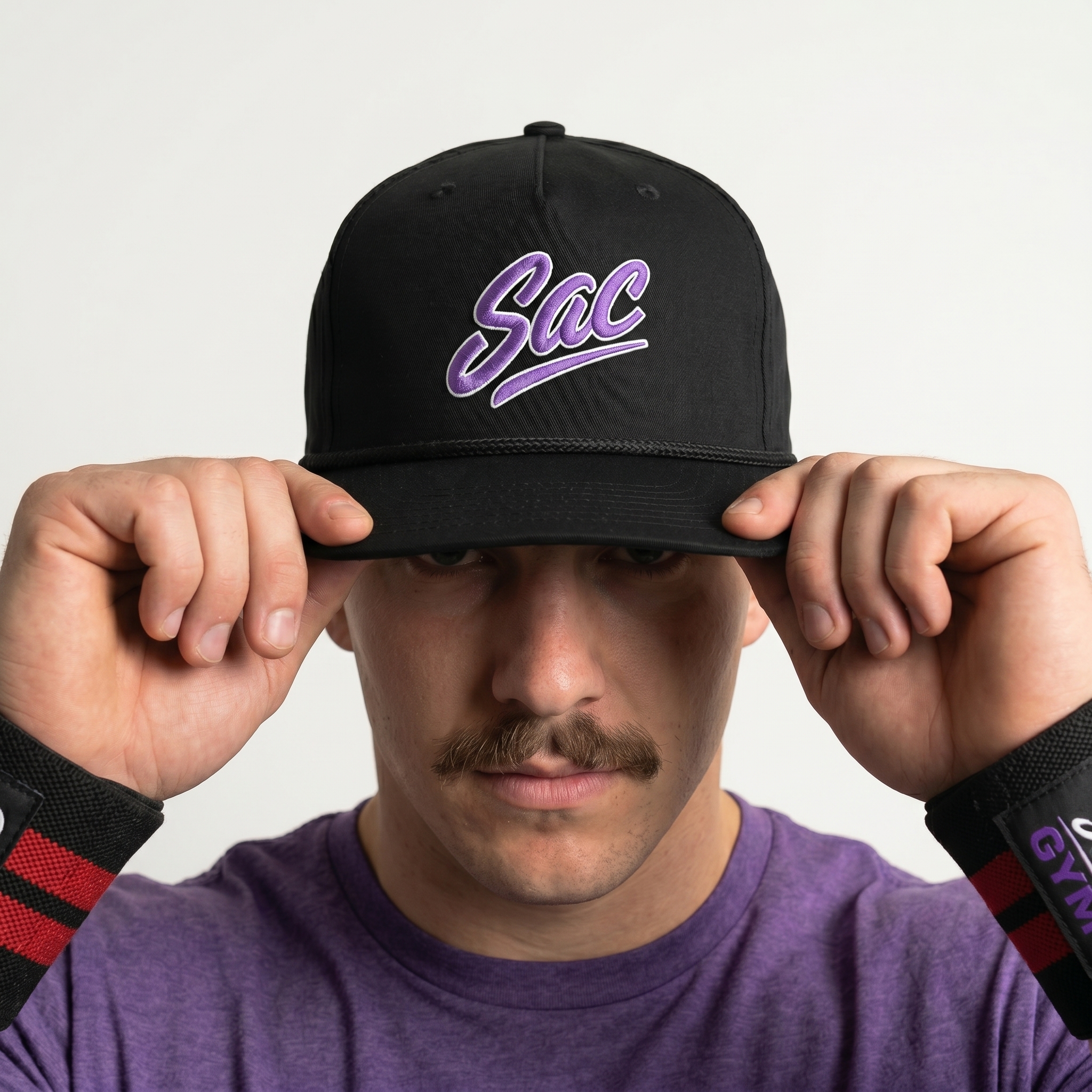 Black rope cap with embroidered purple SAC script logo