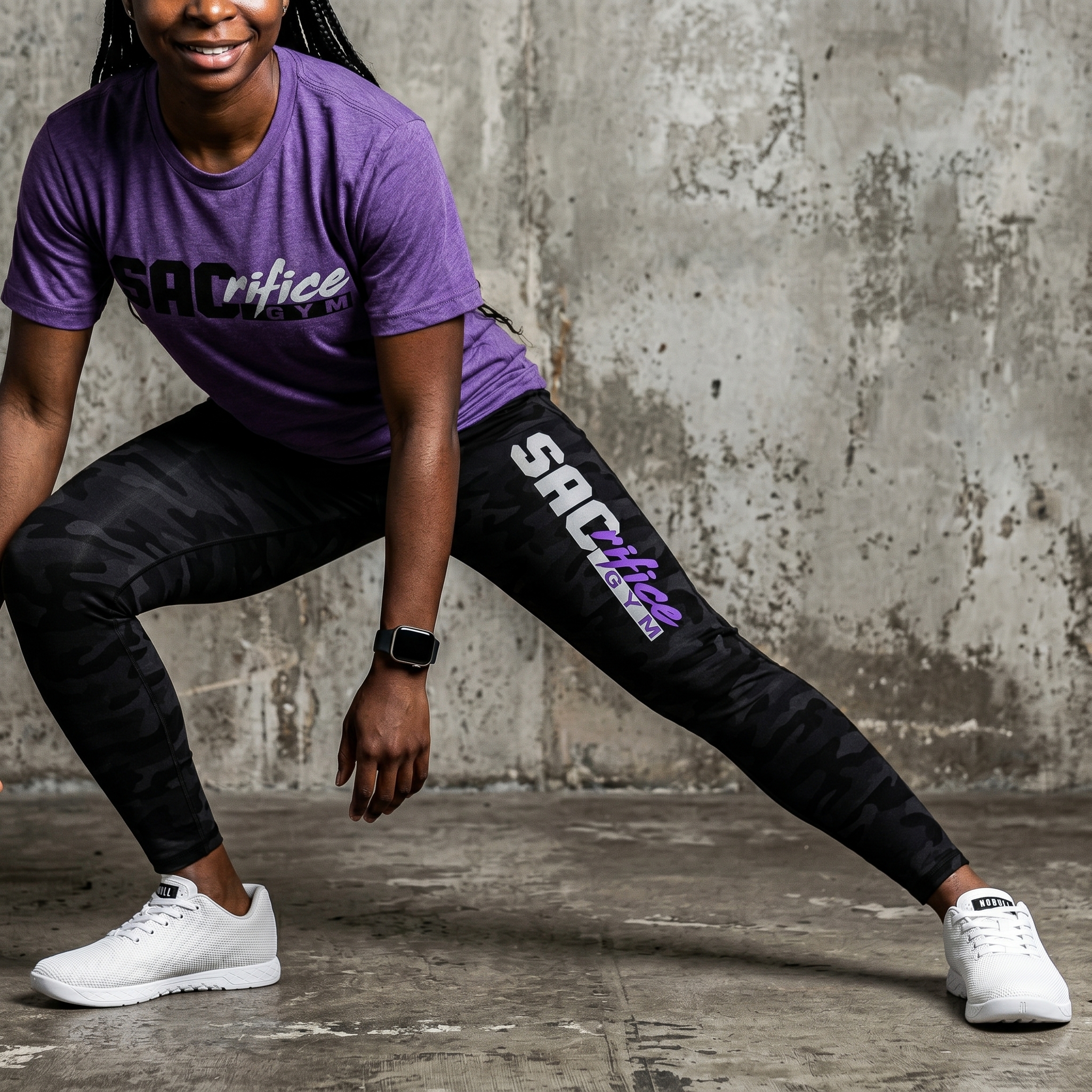 Athlete wearing black camo SACrifice Gym training leggings with vertical SACrifice logo