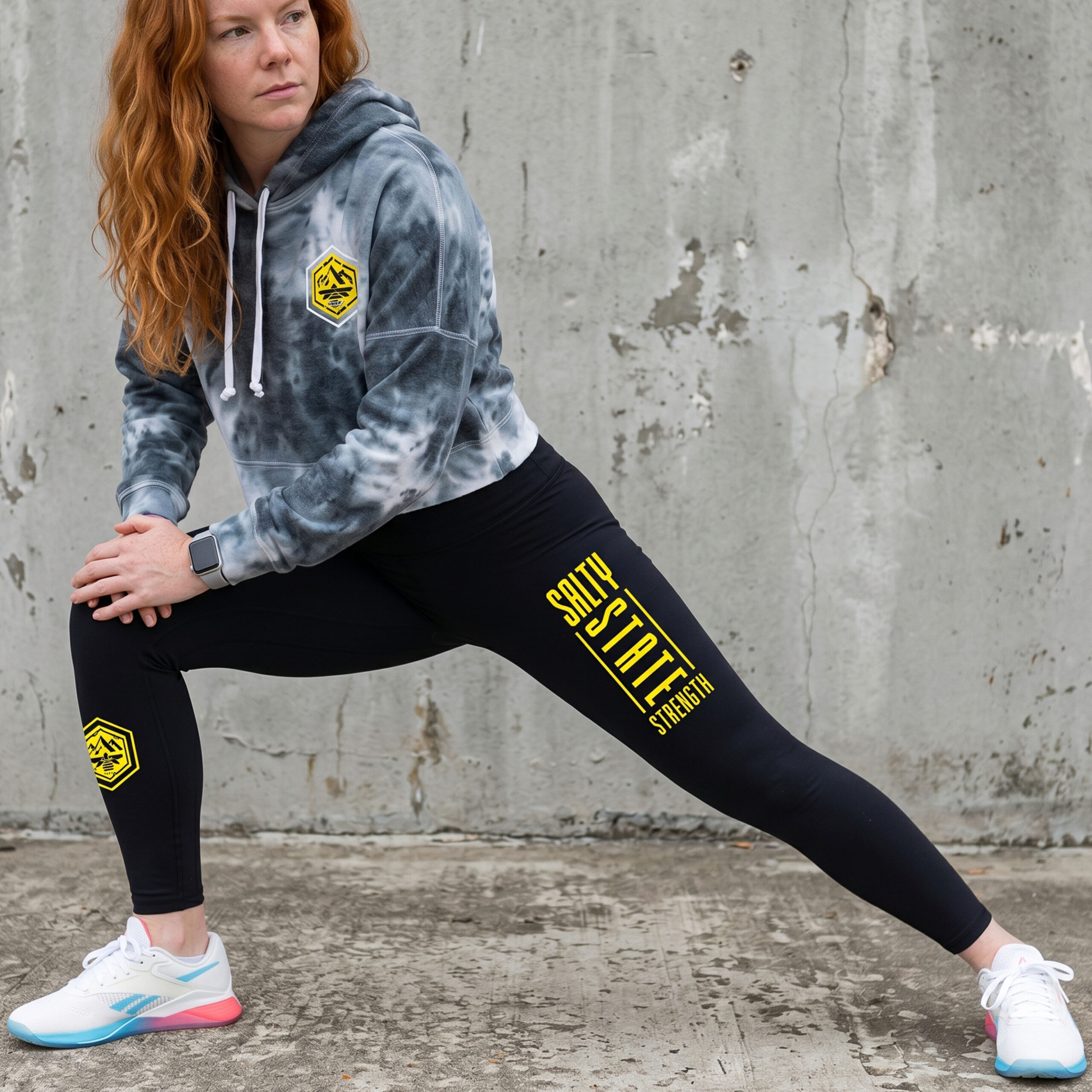 Black Salty State Strength leggings with yellow vertical SLC State Strength print and mountain bee badge