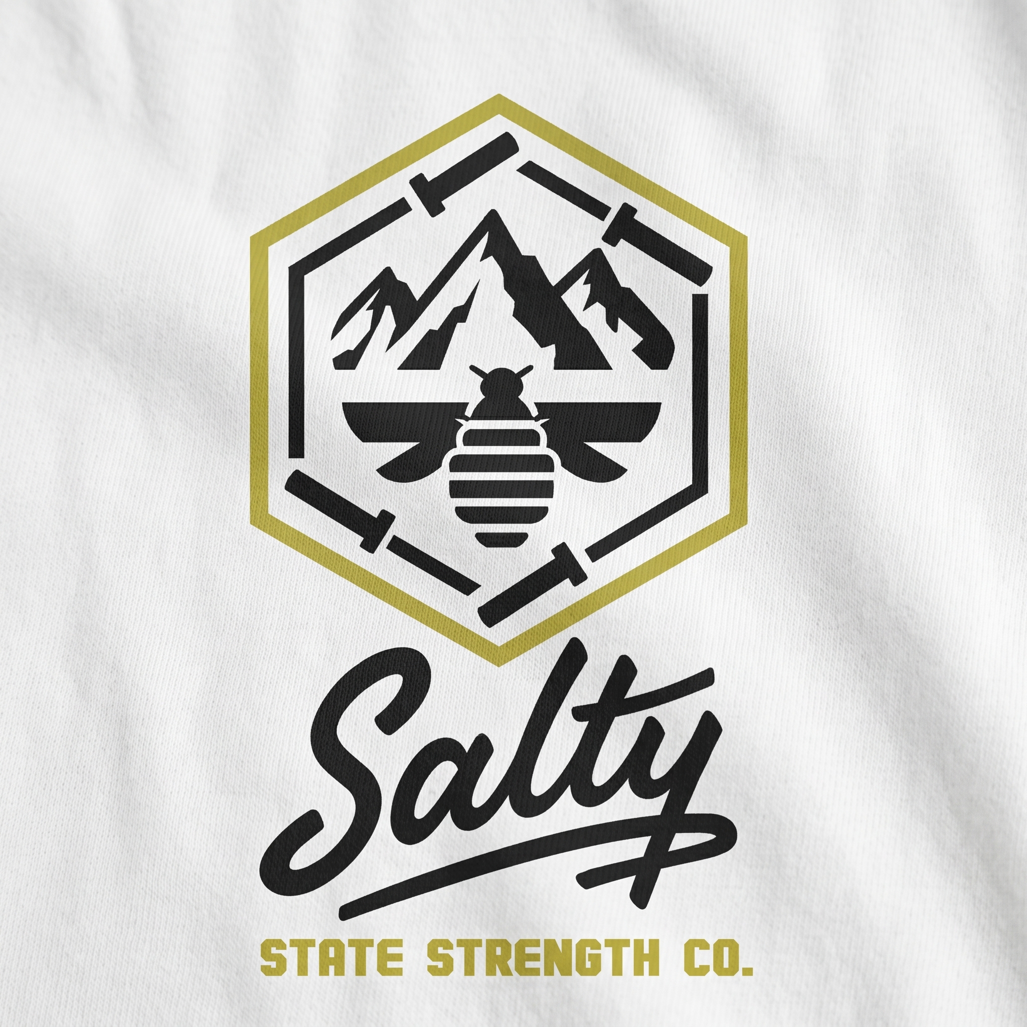 Salty State Strength Co. screen print logo detail with mountain badge, bee, hexagon, barbells, script wordmark, and State Strength Co. type