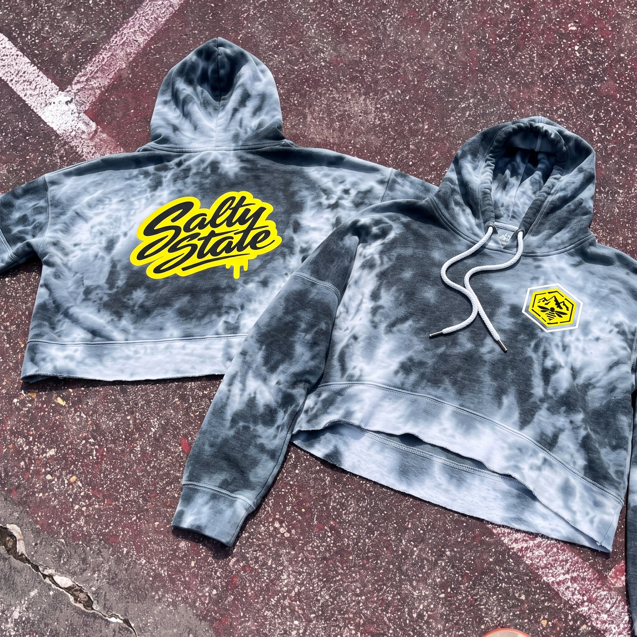 White and yellow raglan tee with Salty State Strength Co. mountain bee badge and script logo on wooden bleachers