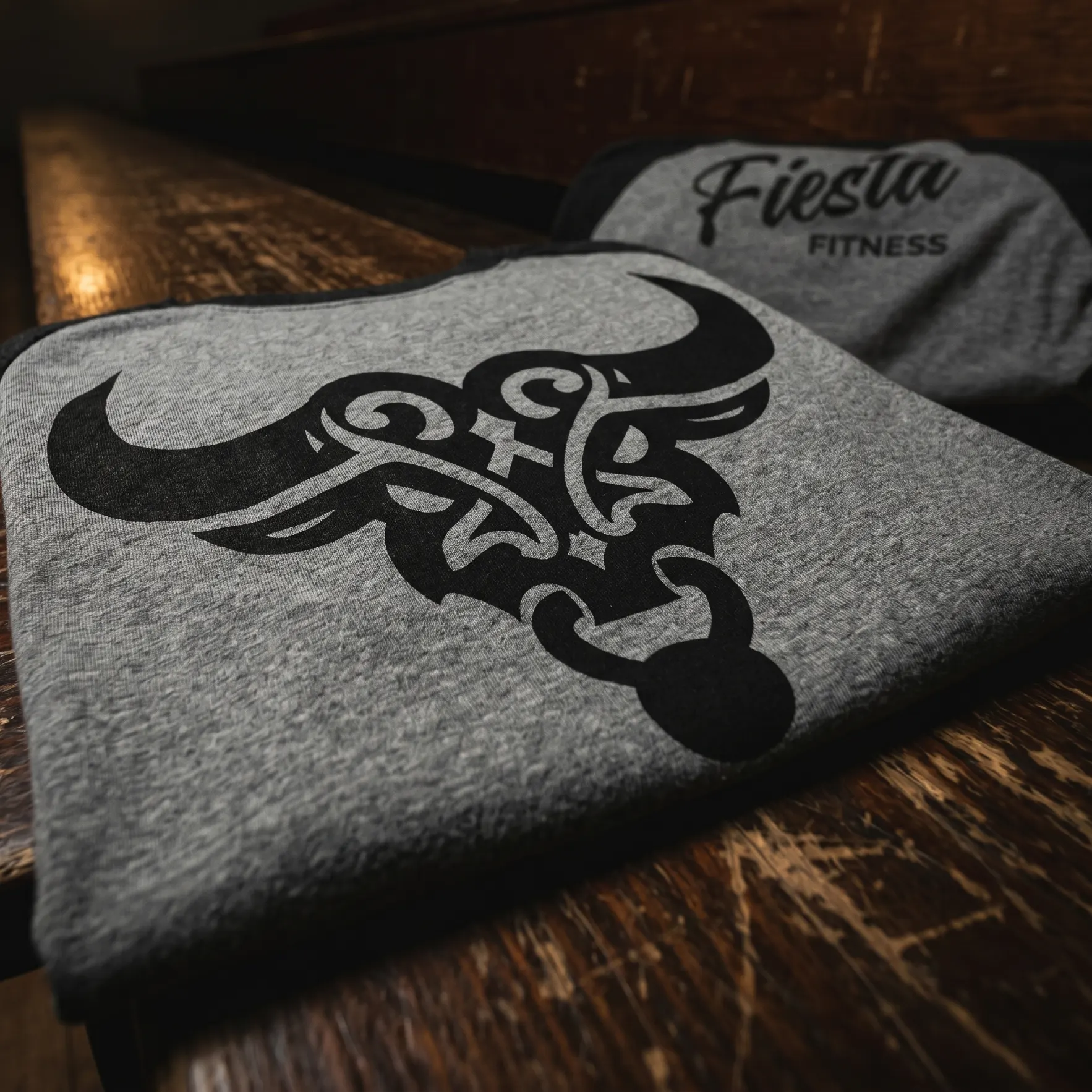 Grey and black Fiesta Fitness raglan tee with large Tejana Gothic bull mascot graphic
