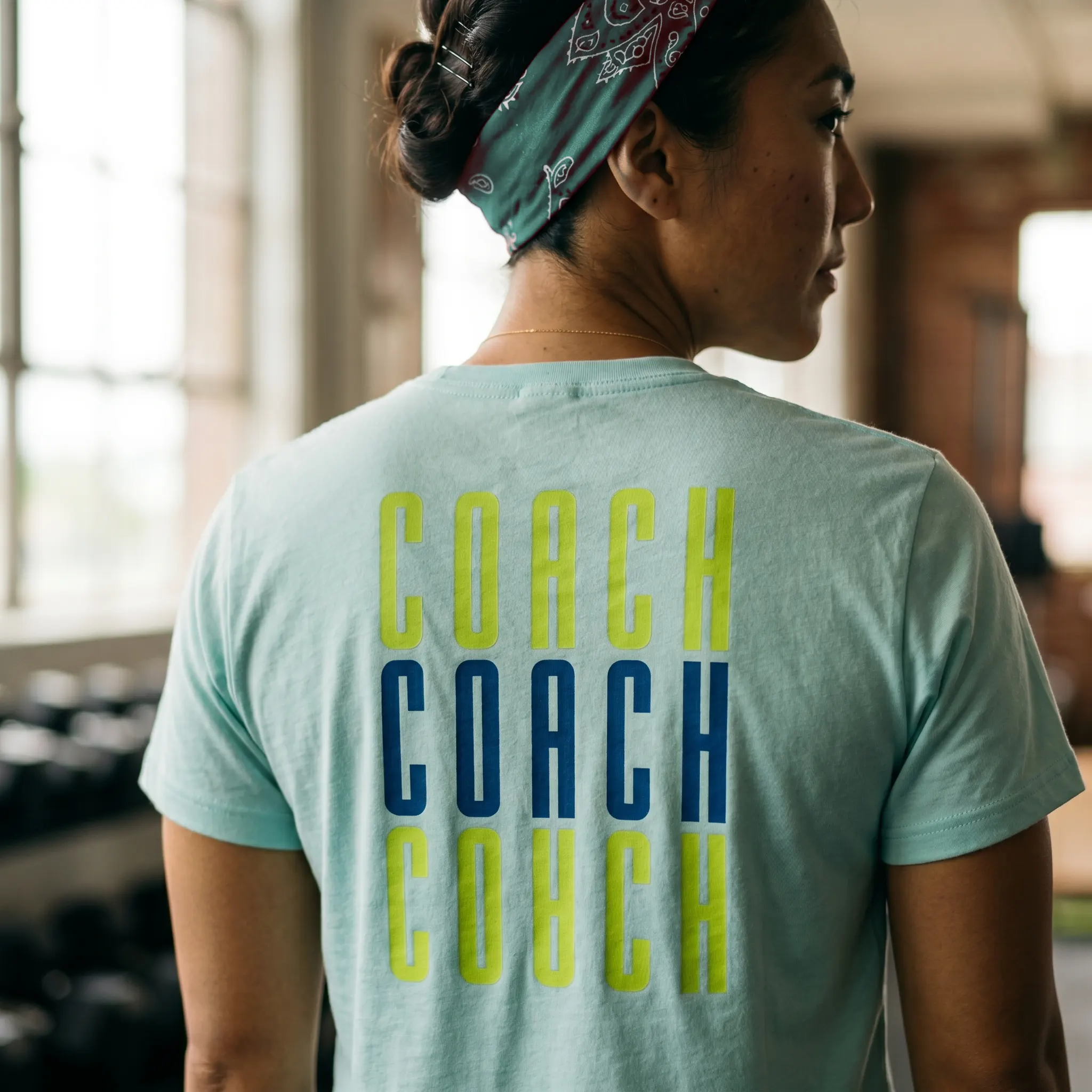 Back of mint Rain City Fitness coach tee with stacked coach typography