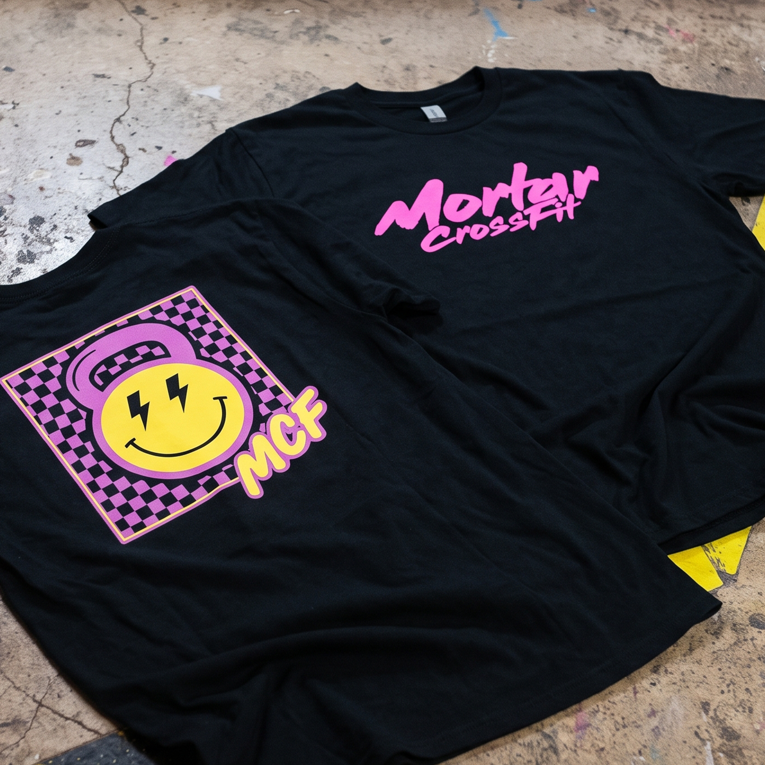 Mortar CrossFit custom Electric Smile Tee with checkerboard smiley graphic and bright pink lettering