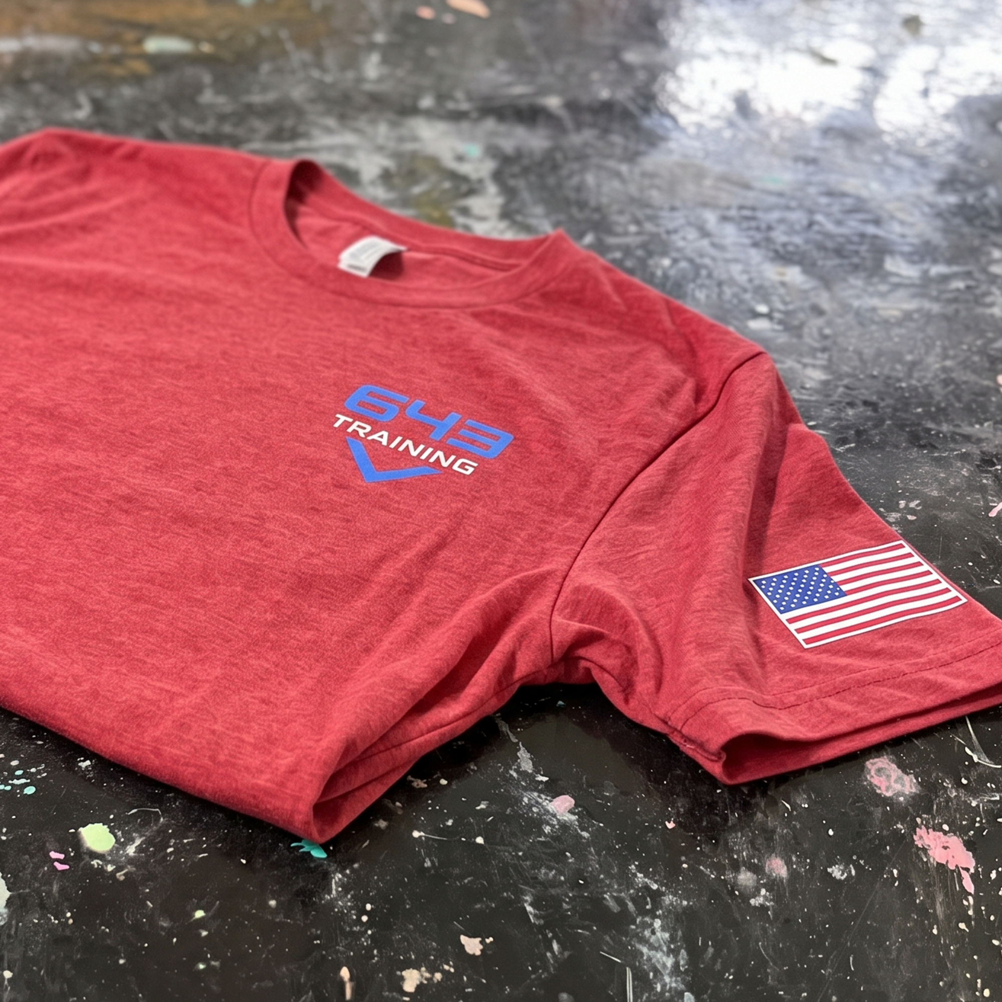 Heather red 643 Training T-shirt with blue chest logo and American flag sleeve print.