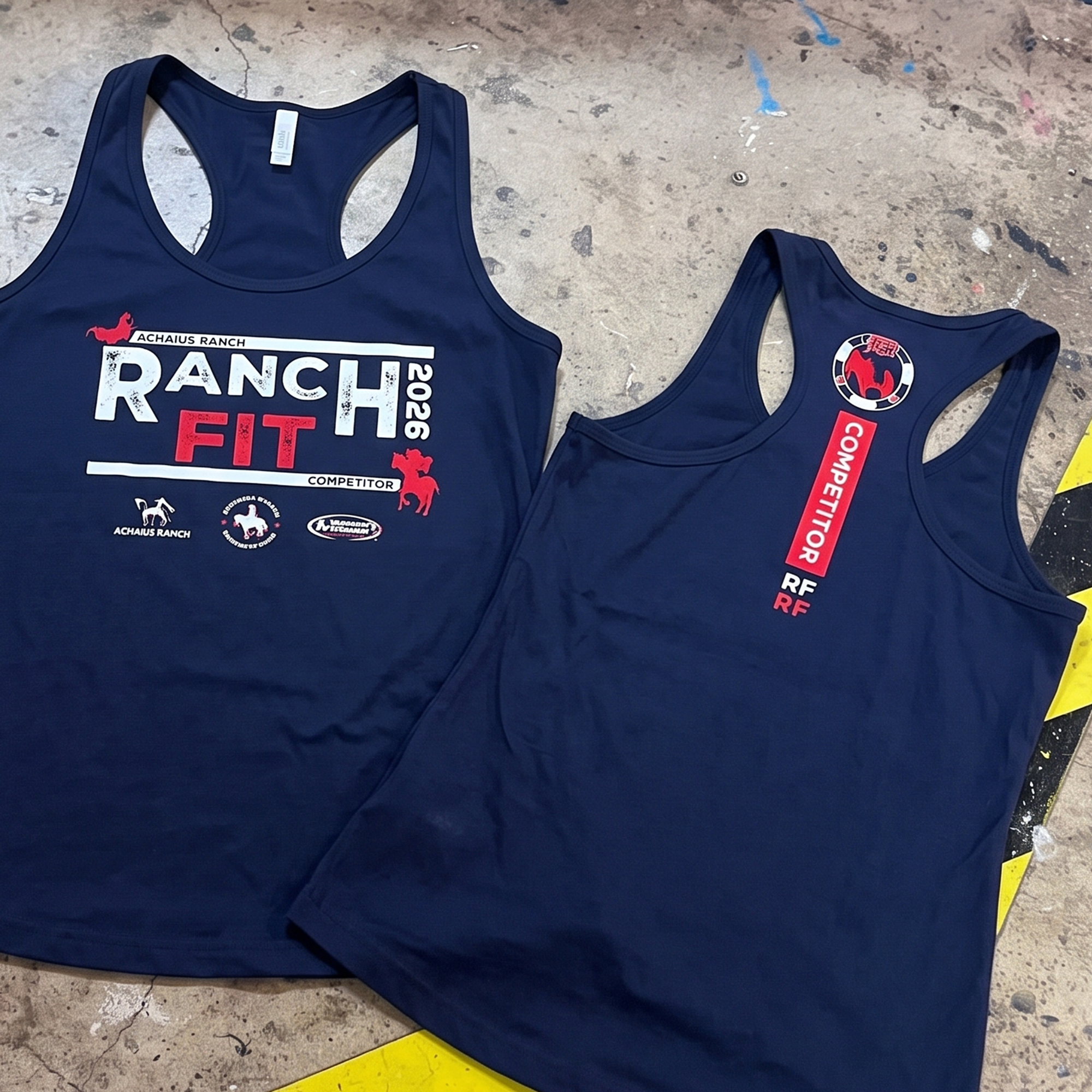 Navy racerback tanks with red and white Ranch Fit 2026 competition graphics on the front and back.