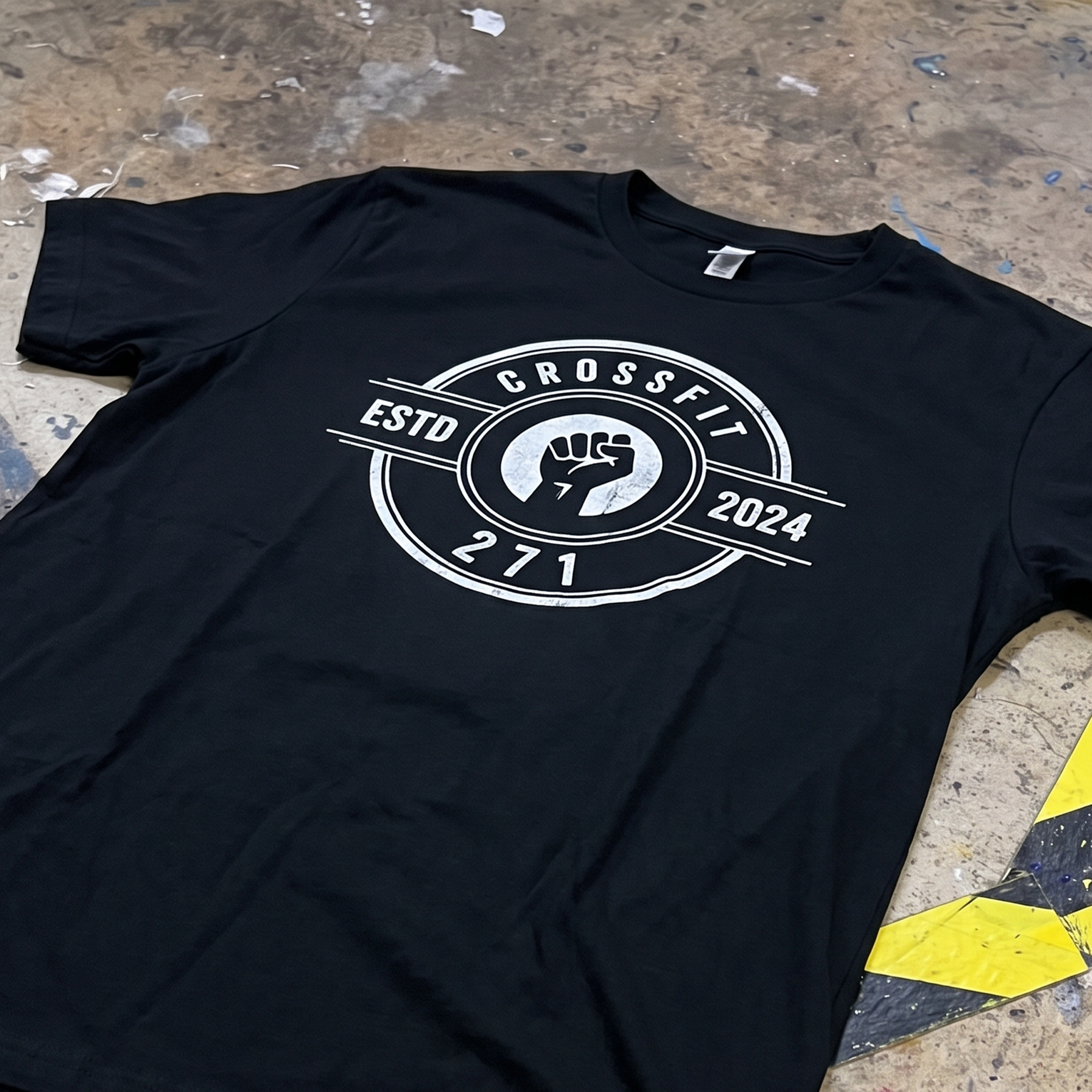Black T-shirt with distressed white CrossFit 271 circular fist badge