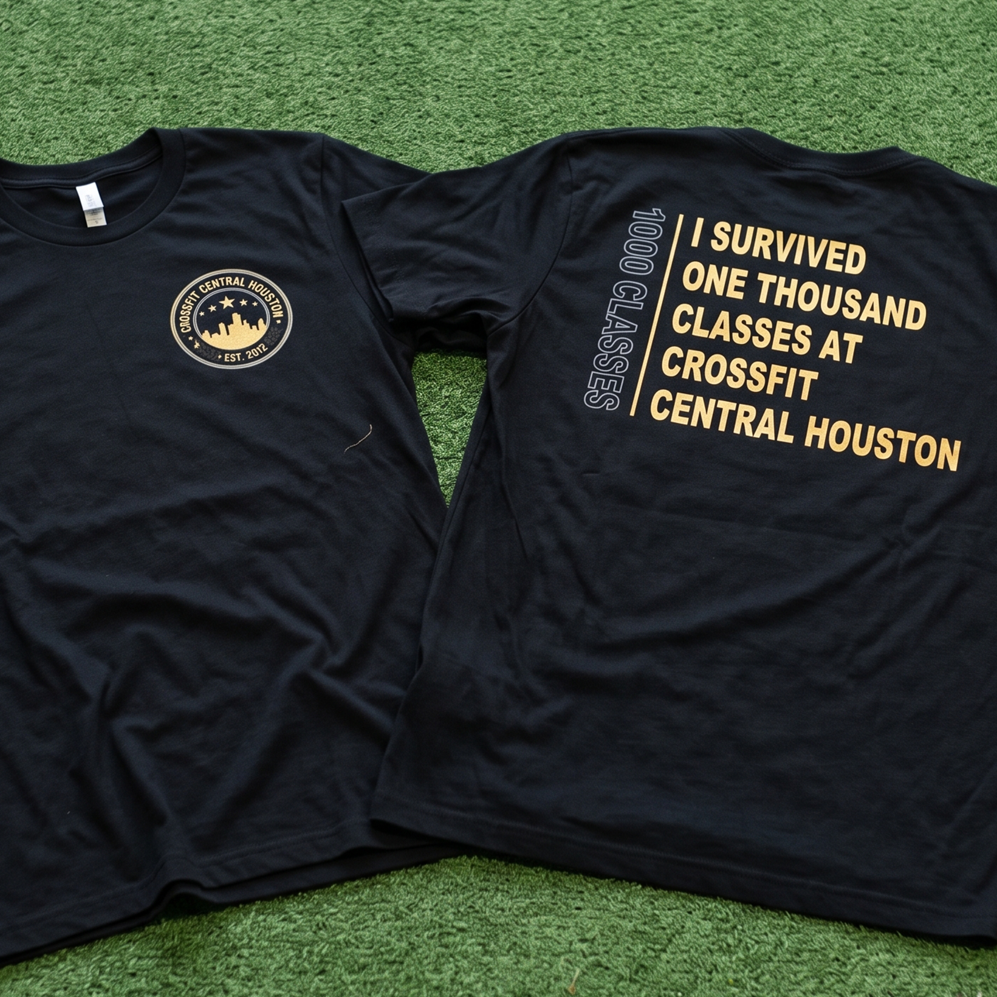 Black tees with a small circular chest crest and large gold 1,000-class back print.