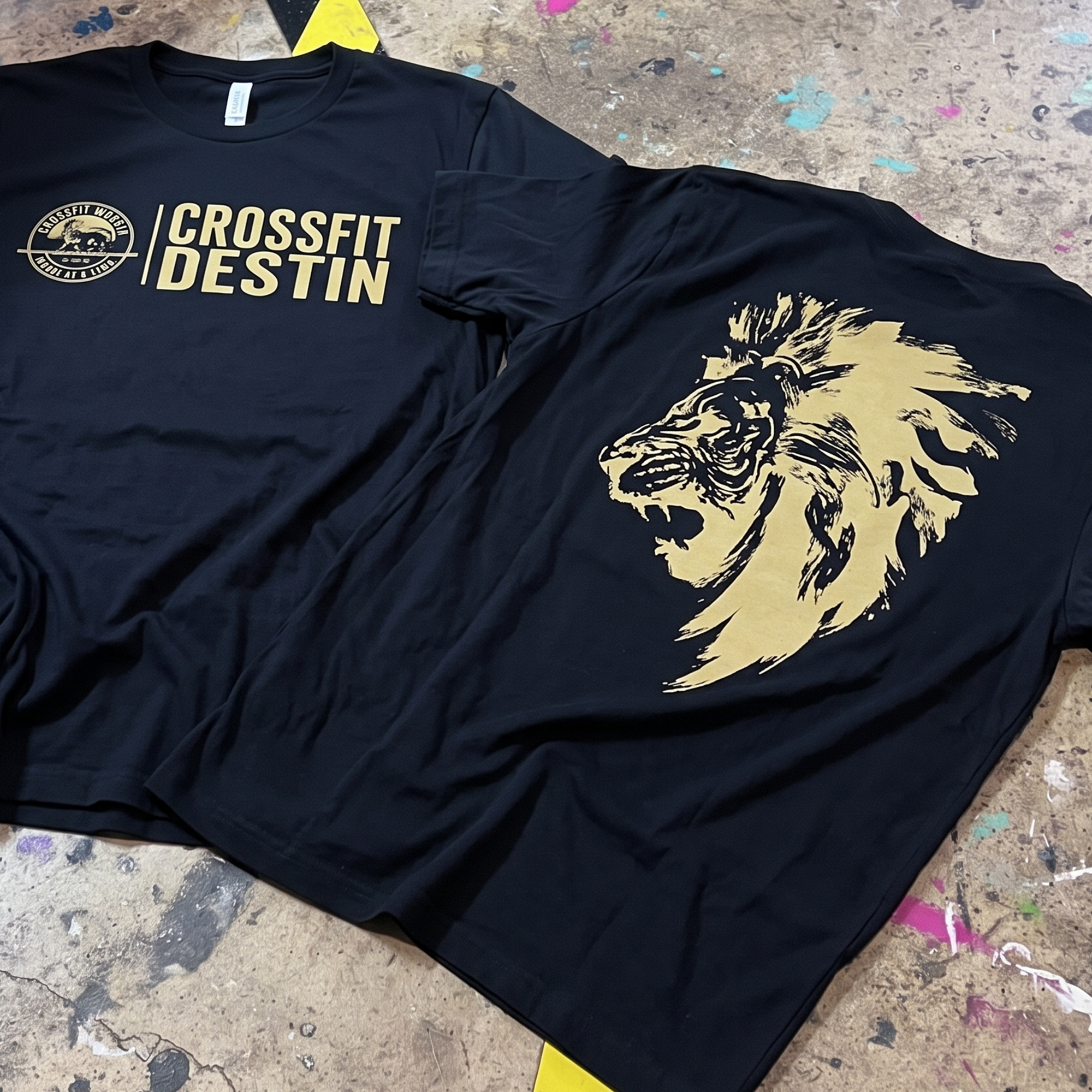 Black CrossFit Destin tees with cream front lettering and large lion back graphic.