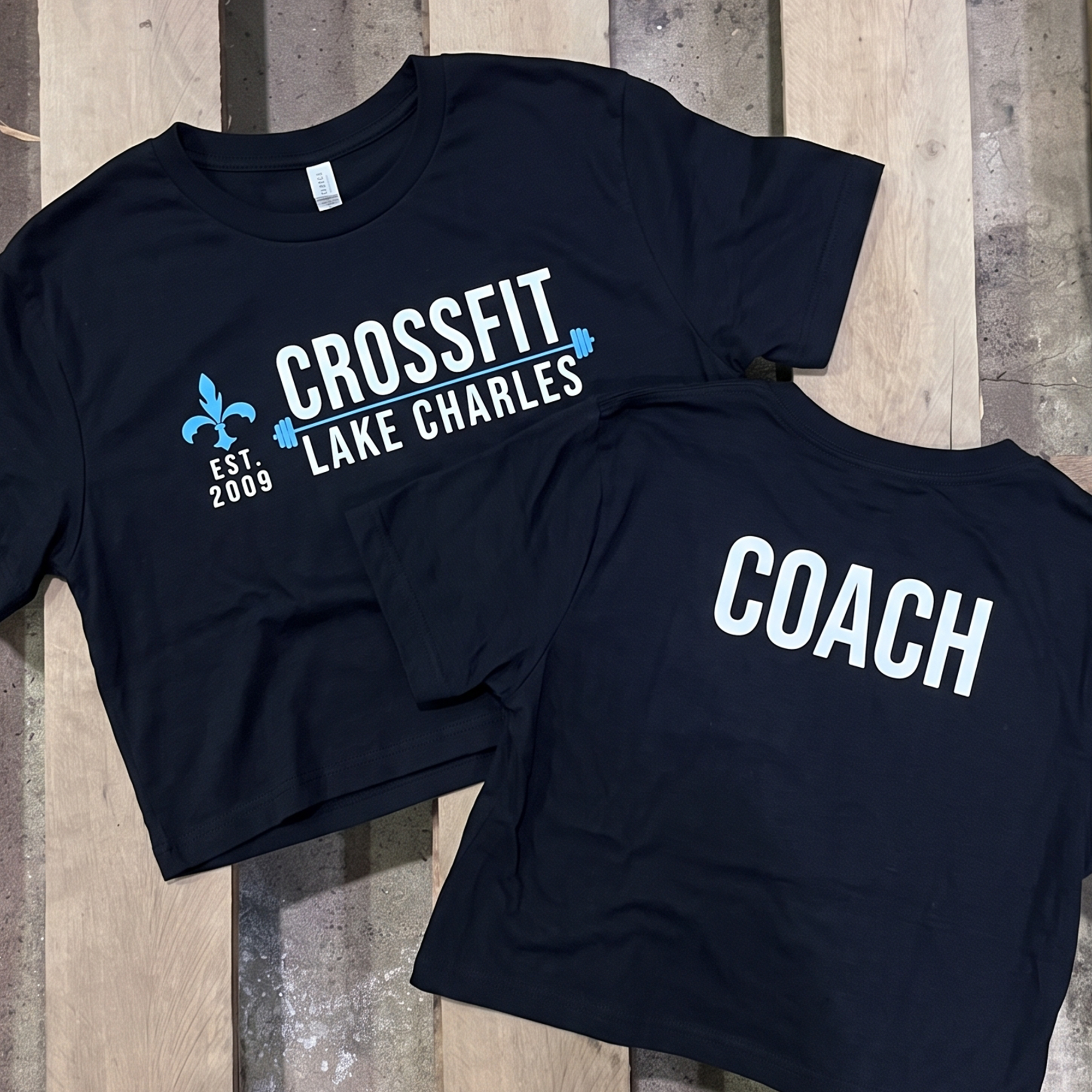 Navy CrossFit Lake Charles coach tees with white and blue front logo and large white COACH back print.