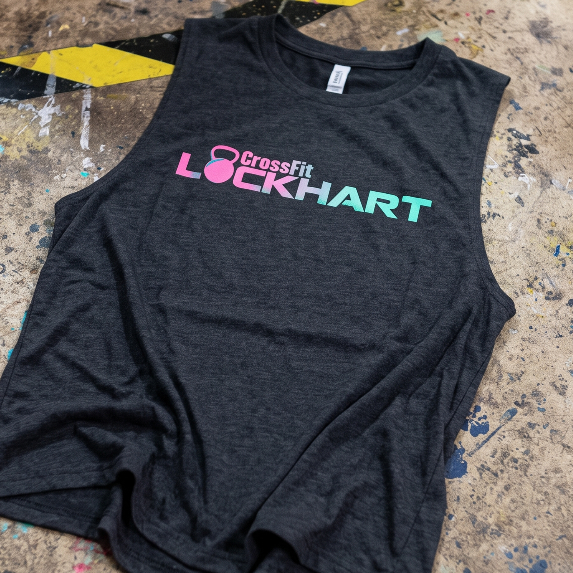 Dark racerback tank with pink and teal CrossFit Lockhart kettlebell logo