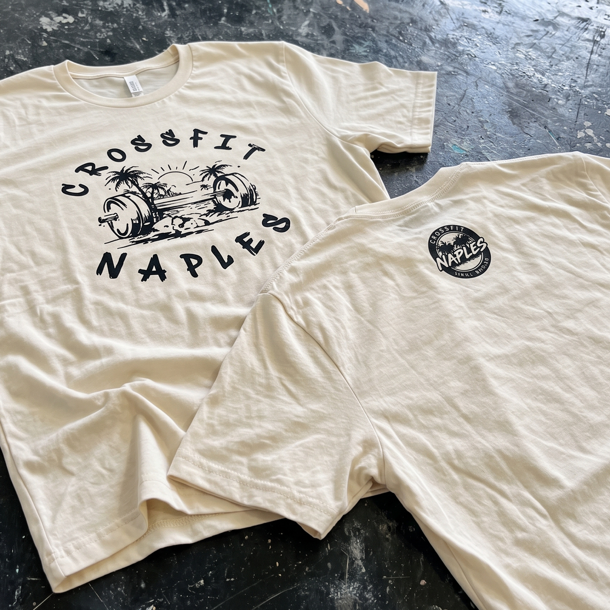 Cream CrossFit Naples tees with black barbell and palm tree graphics.