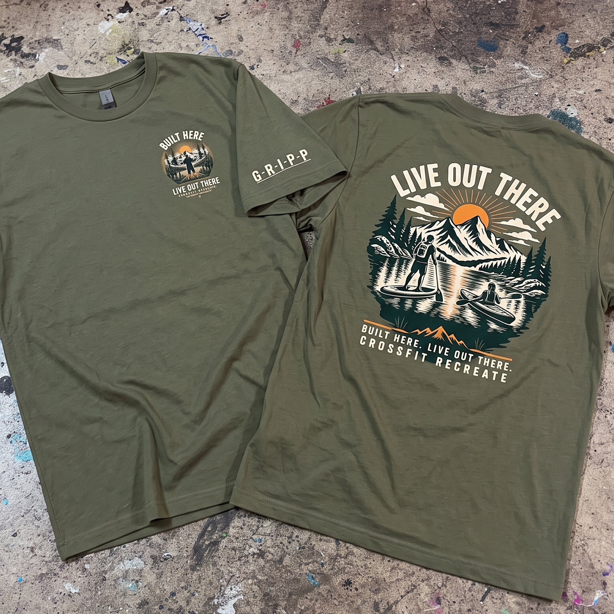 Olive green tee with small chest graphic and large mountain, sunrise, paddleboard and canoe back print.
