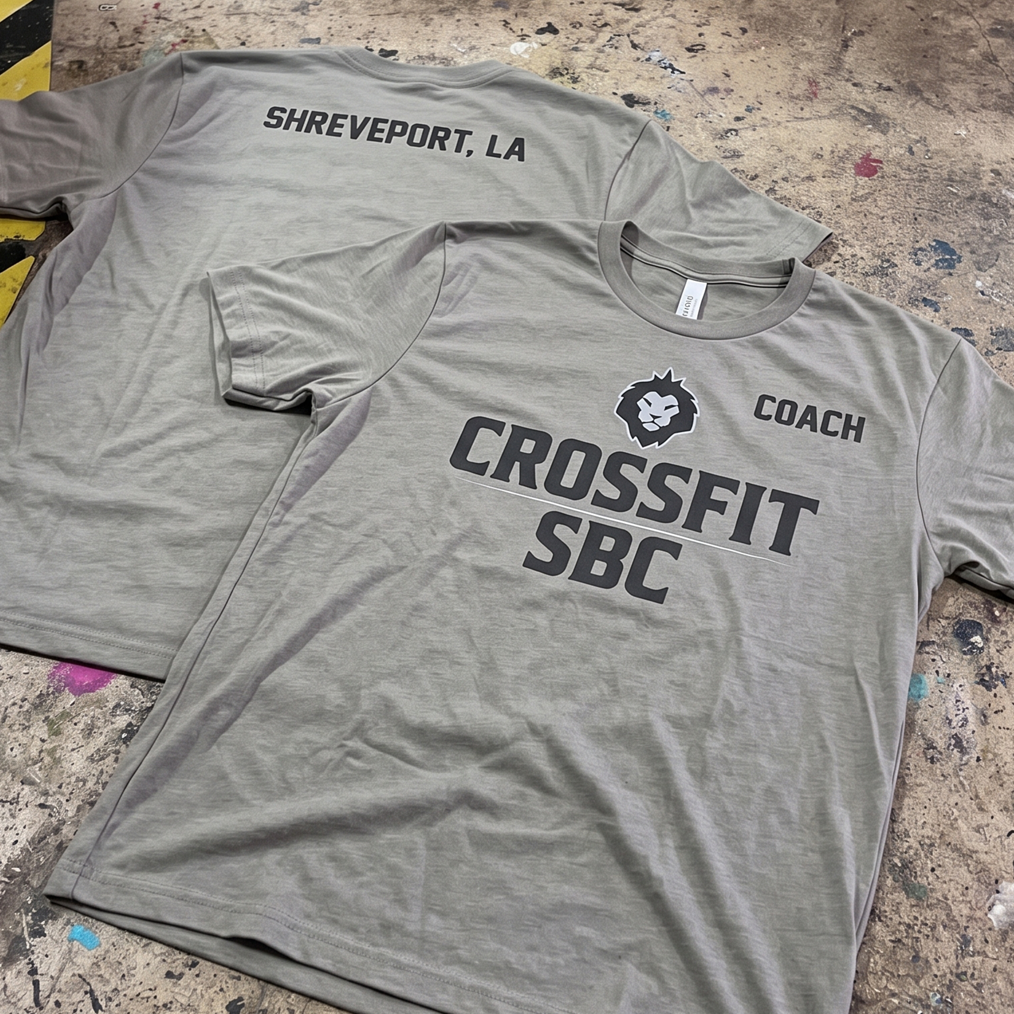 Gray CrossFit SBC coach shirts with black front graphics, coach sleeve print, and Shreveport, LA back print.