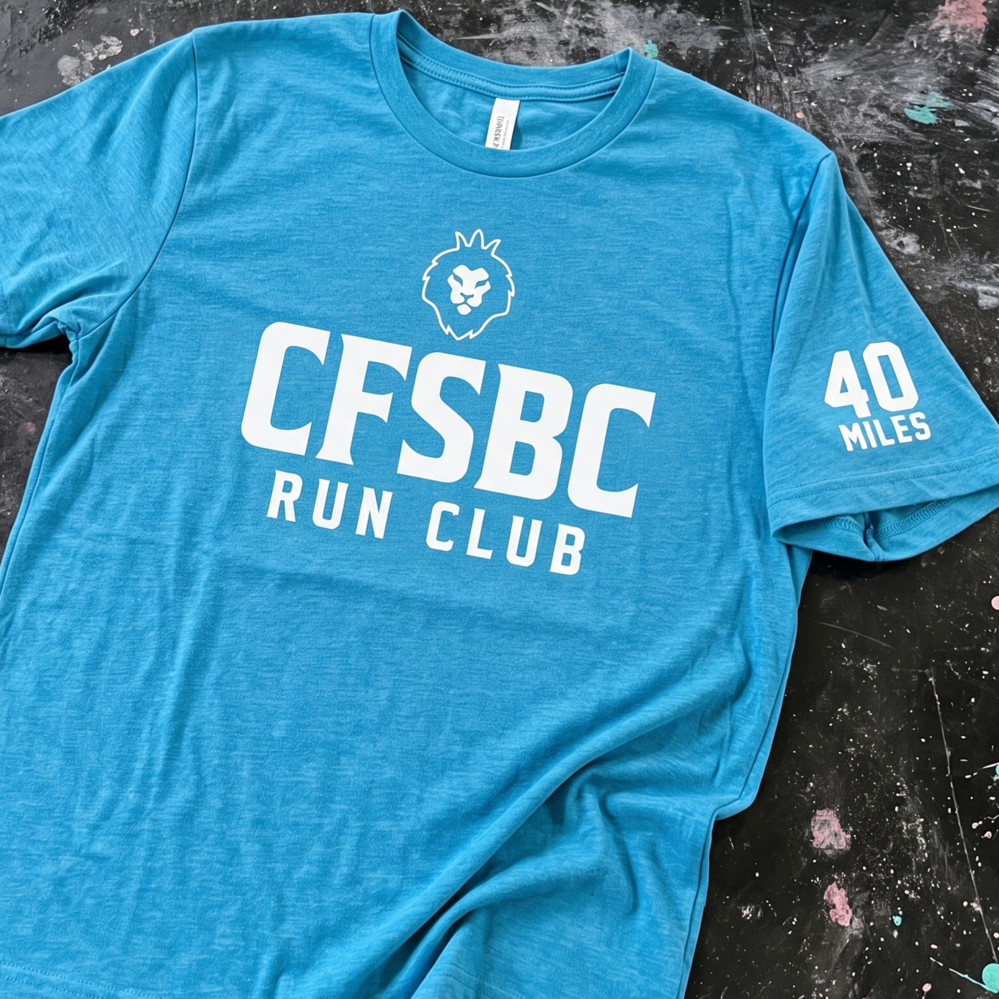 Bright blue CrossFit SBC Run Club T-shirt with white lion logo, large front lettering, and 40 Miles sleeve print.