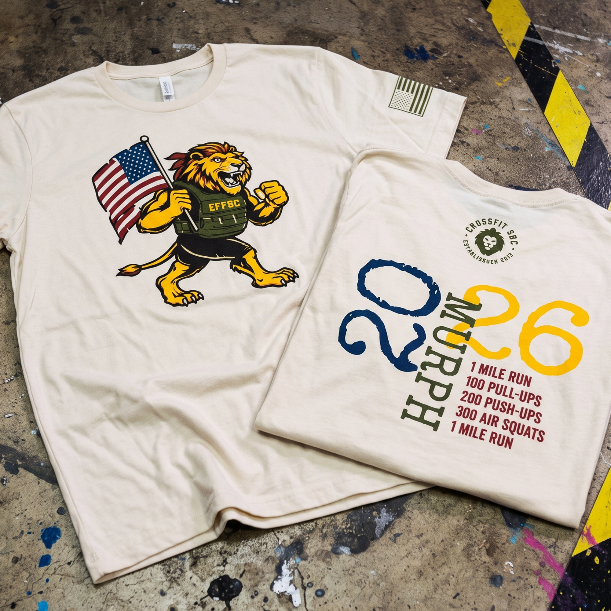 Cream tees with a lion holding an American flag, Murph 2026 text, workout details, and an olive sleeve flag.