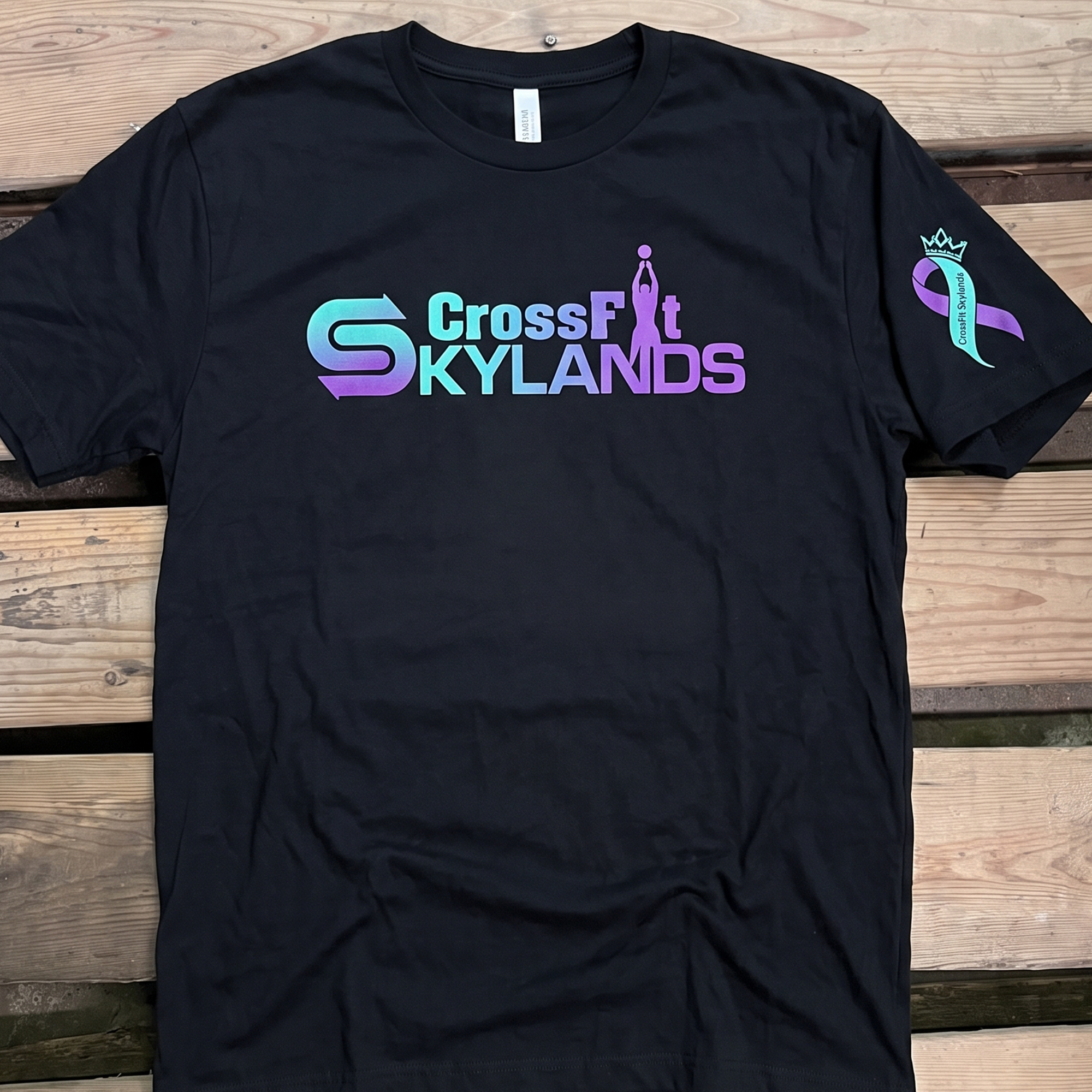Black CrossFit Skylands tee with turquoise and purple gradient front logo and crowned sleeve graphic.