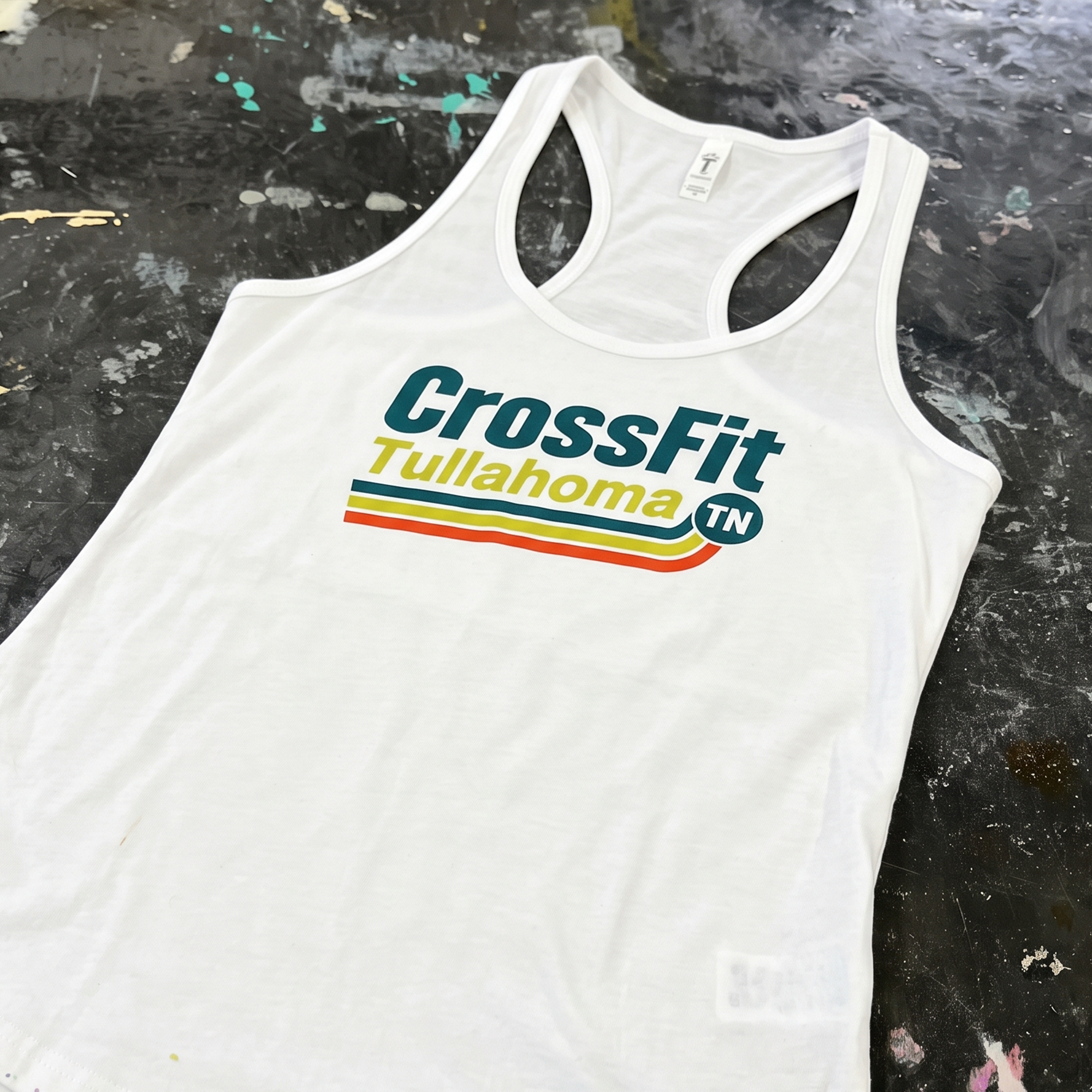 White racerback tank with CrossFit Tullahoma retro stripe chest print.