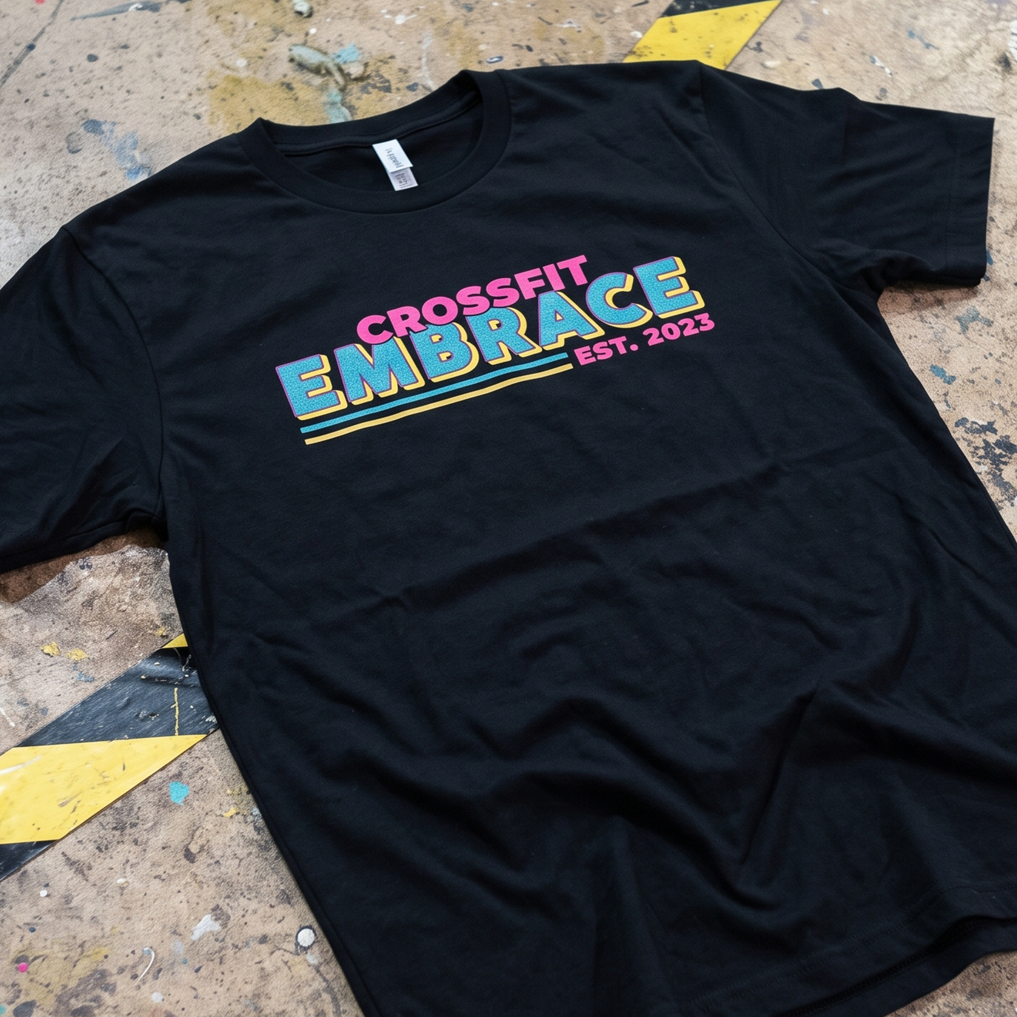 Black T-shirt with colorful retro CrossFit Embrace front print.