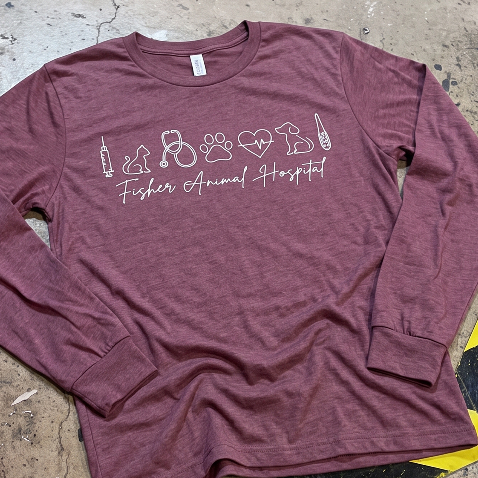 Berry long-sleeve shirt with white veterinary icons and Fisher Animal Hospital script