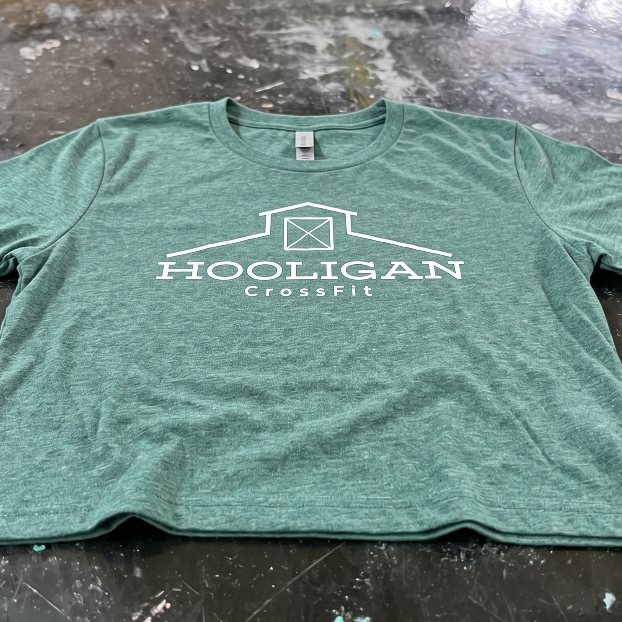 Heathered green T-shirt with white Hooligan CrossFit barn logo on the front.