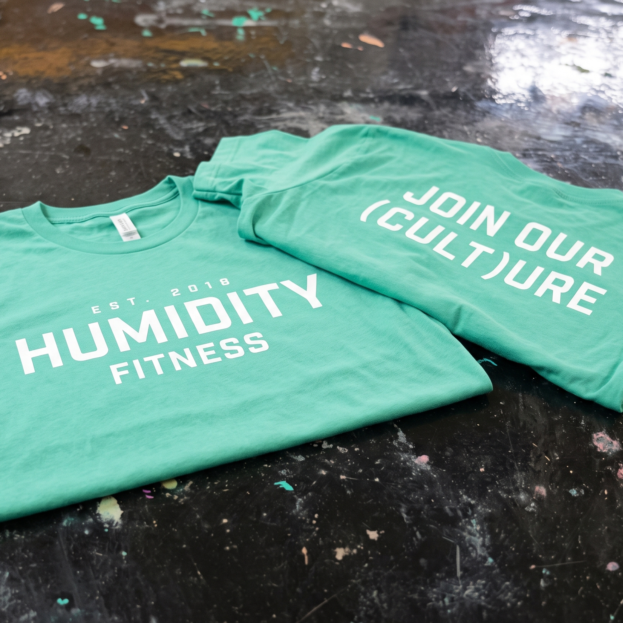 Seafoam Humidity Fitness tee with white front logo and back culture message.