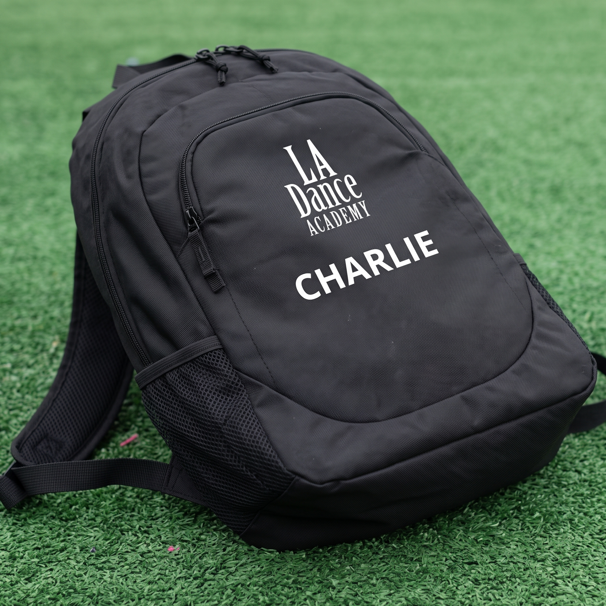 Black backpack with white LA Dance Academy logo and Charlie personalization.