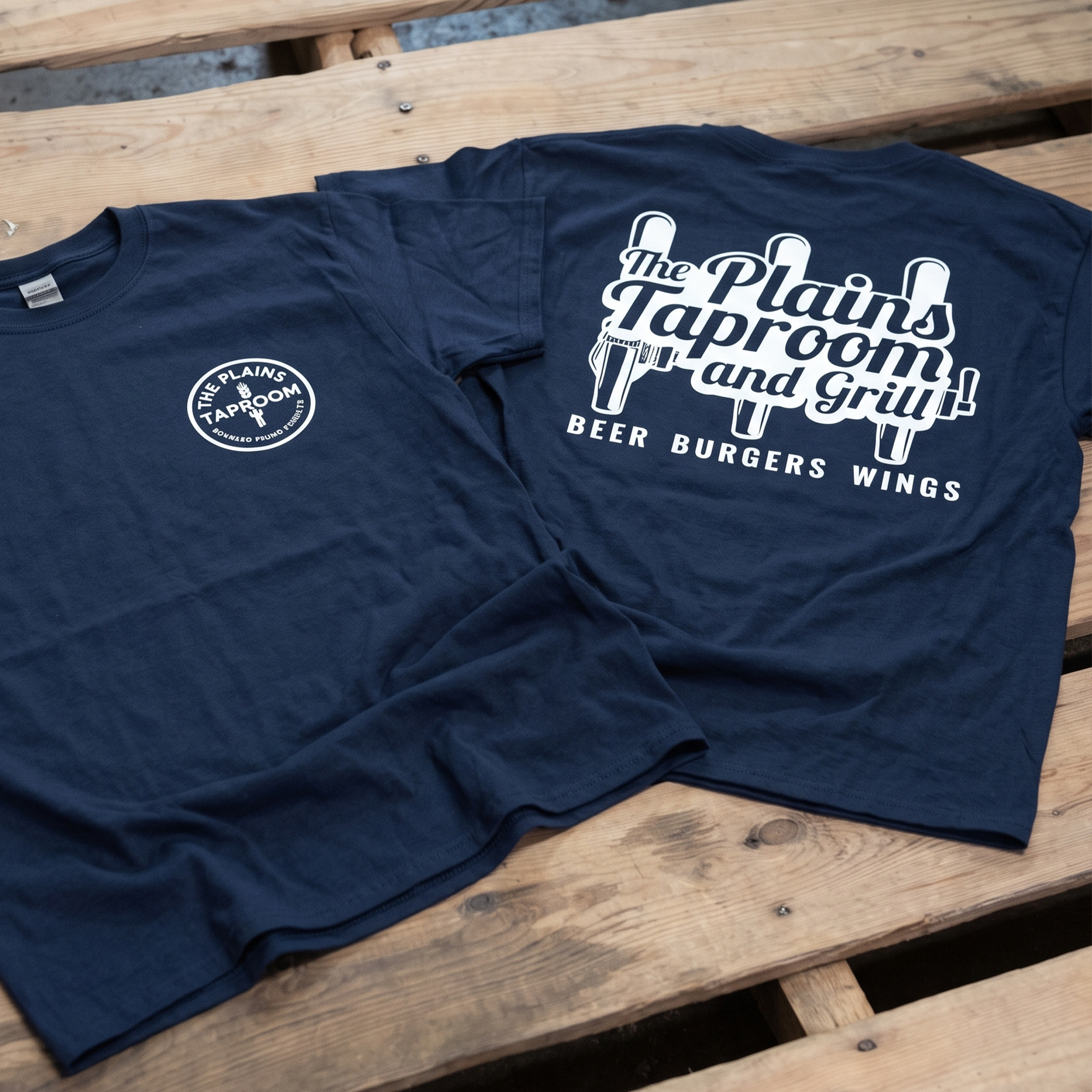 Navy T-shirt with circular chest logo and large white taproom back print.