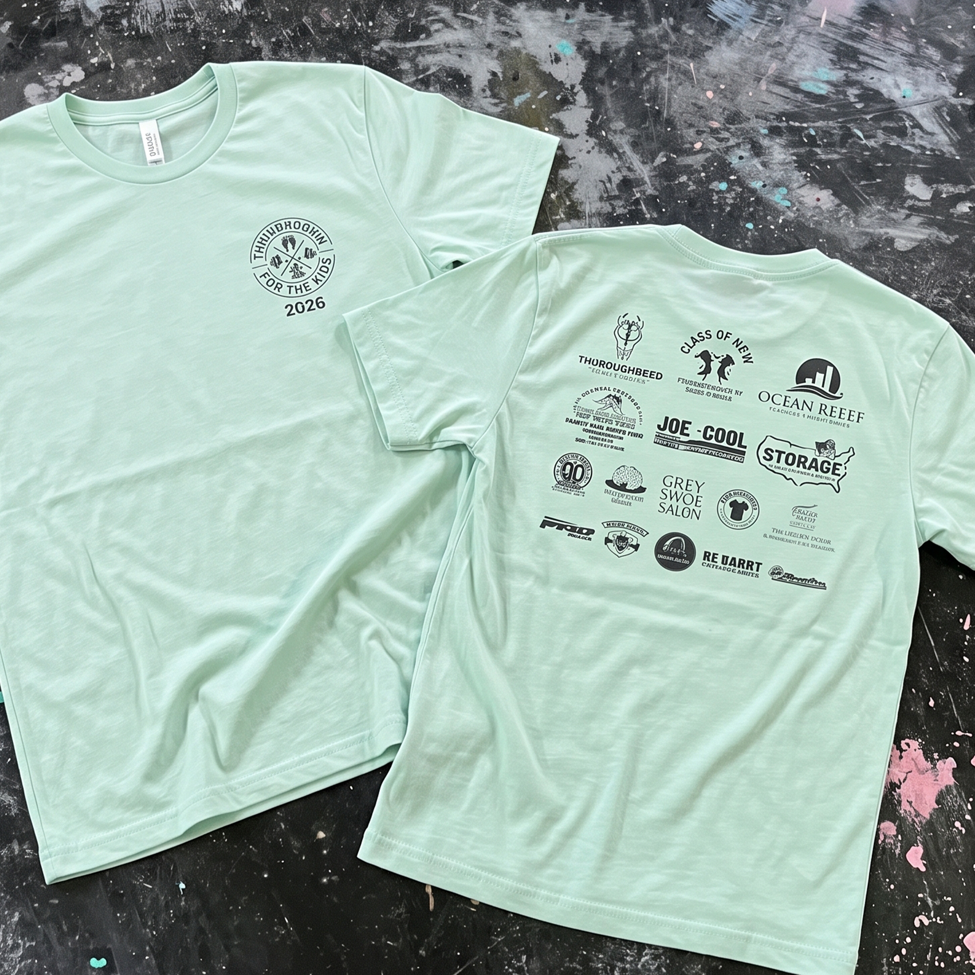 Mint green event T-shirts with a small Throwdown for the Kids 2026 chest crest and black sponsor logos on the back.