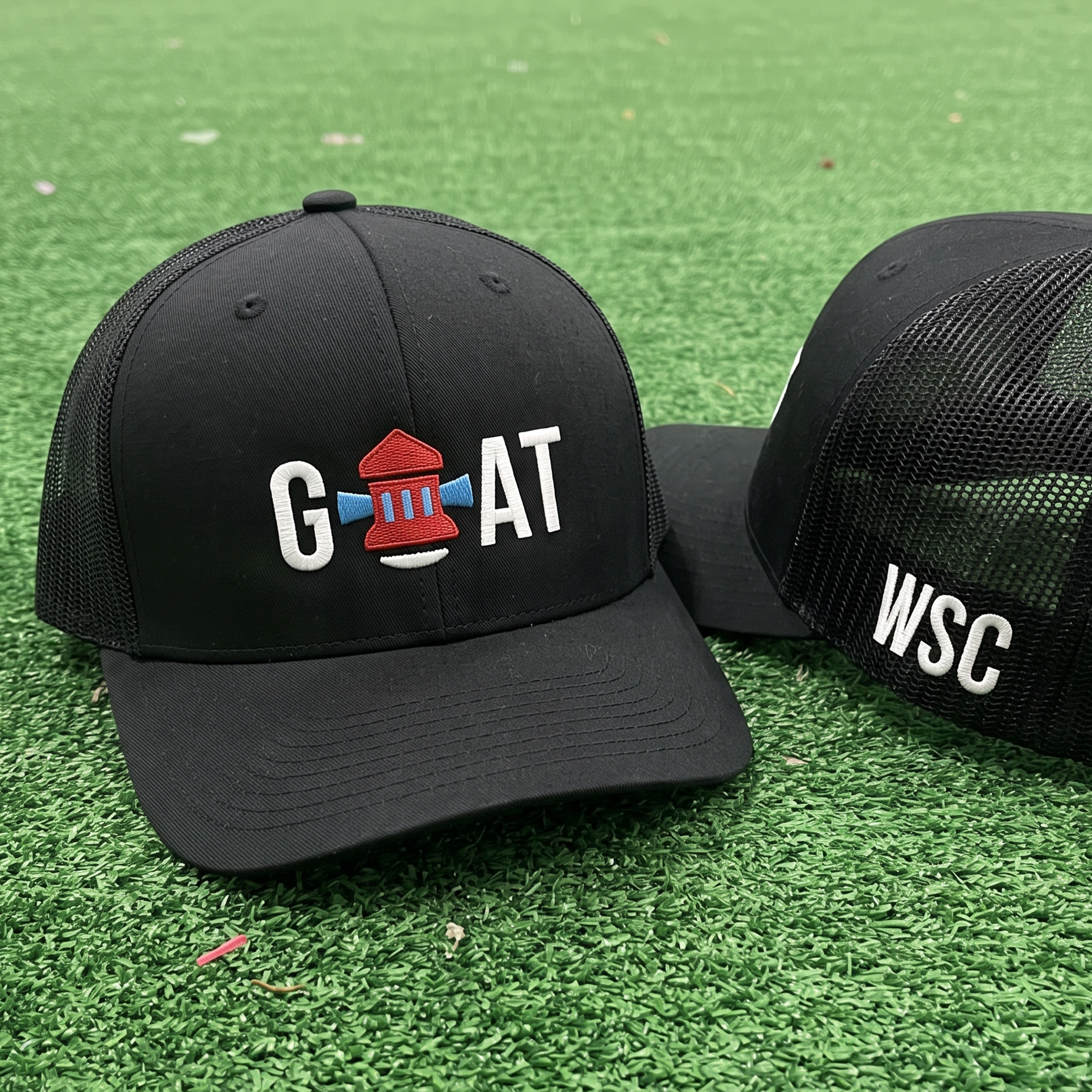 Black trucker hats with embroidered GOAT barbell logo and WSC side lettering.