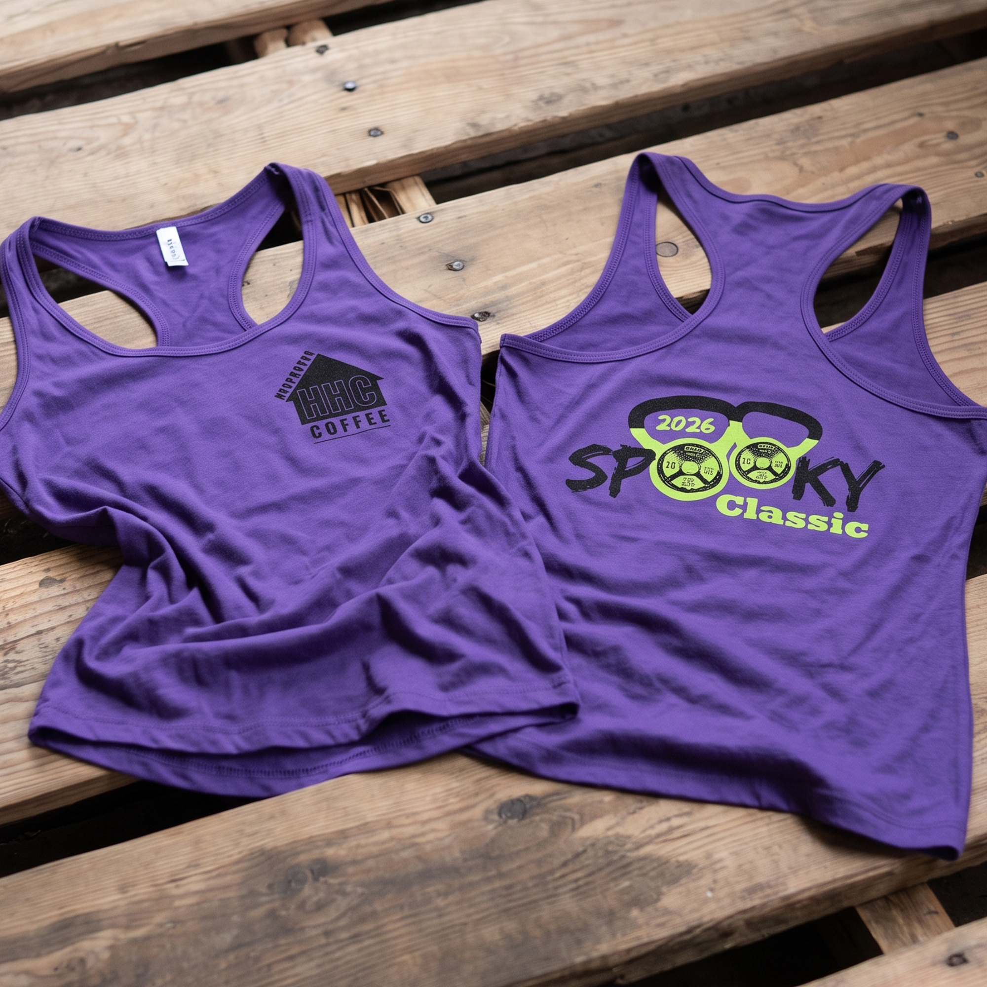 Purple racerback tanks with black chest logos and neon green Spooky Classic kettlebell print.